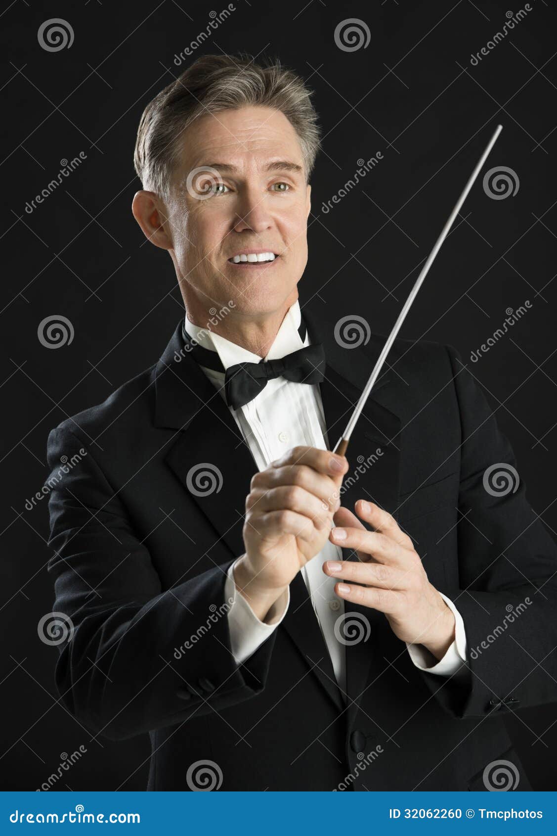 music conductor smiling while directing with his baton