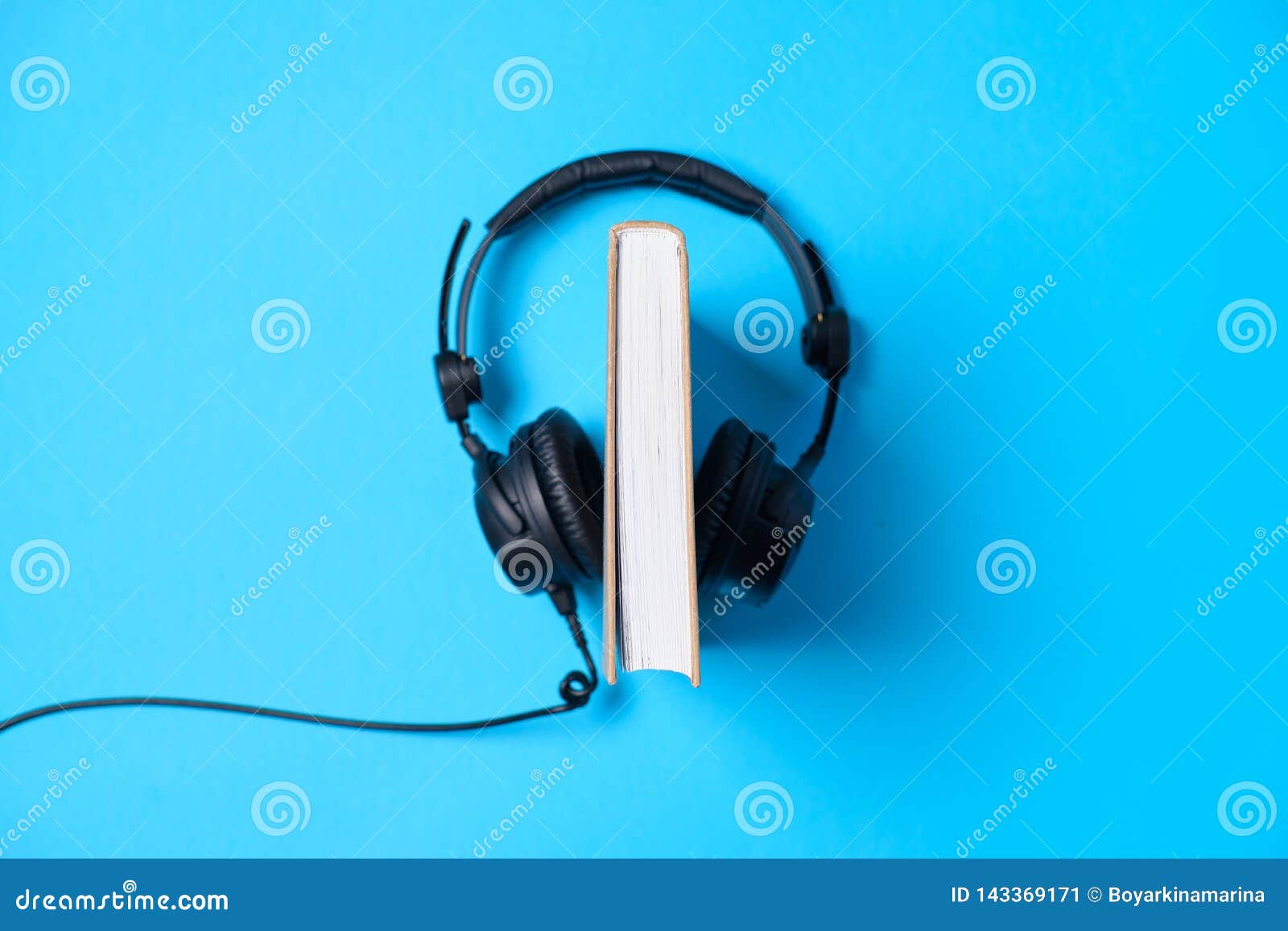 Music or Podcast Background Headphones with a Book on Blue Table, Flat Lay.  Top View, Flat Lay Stock Image - Image of media, online: 143369171