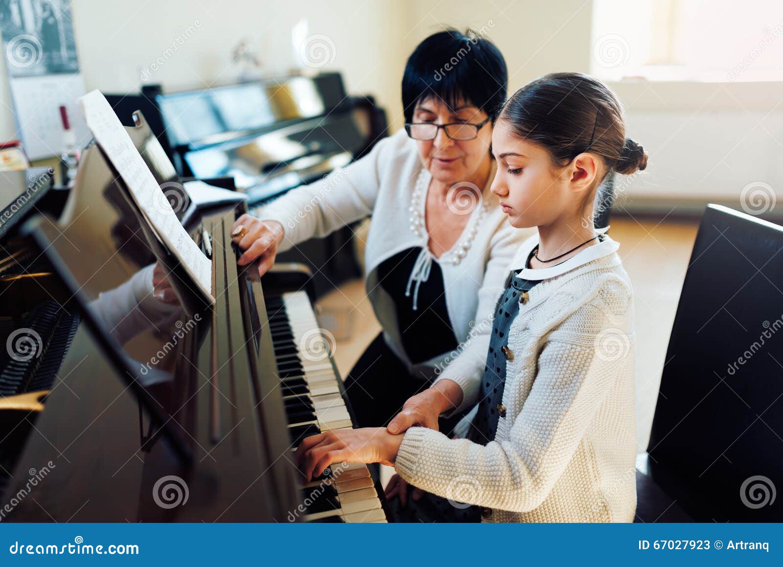 music teacher with the pupil at lesson piano