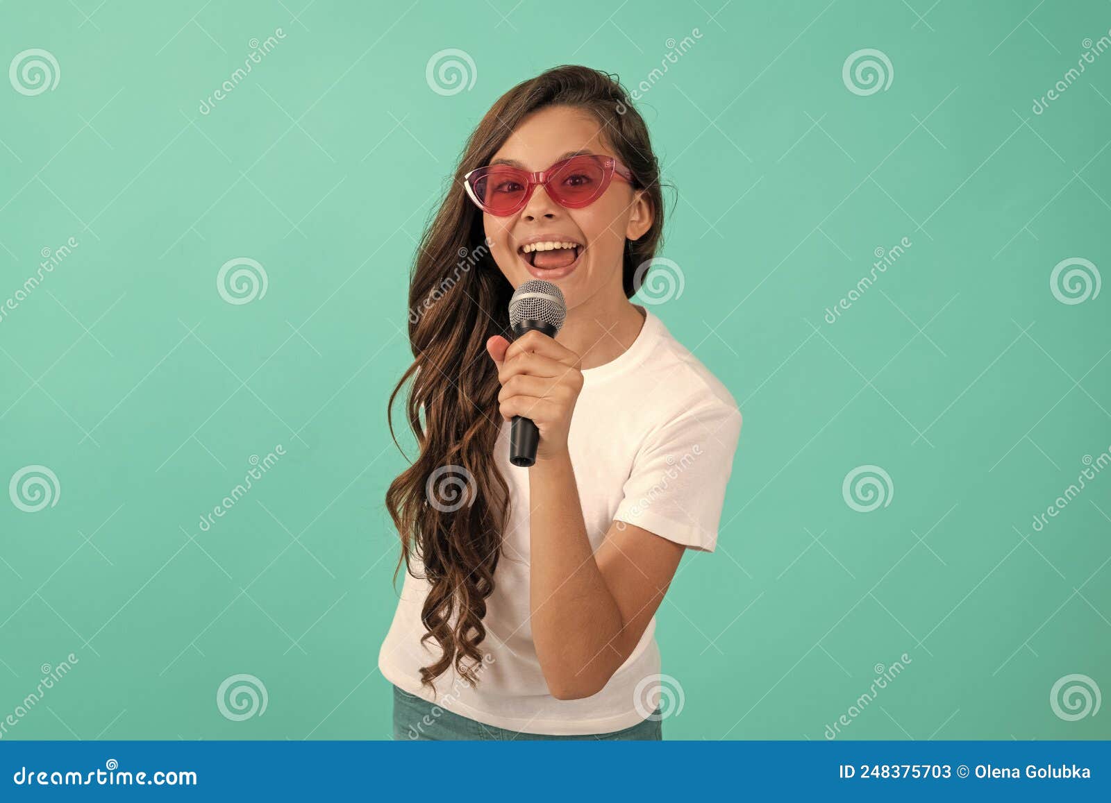 music is what i am. happy child sing song. karaoke and live music. girl singer hold microphone