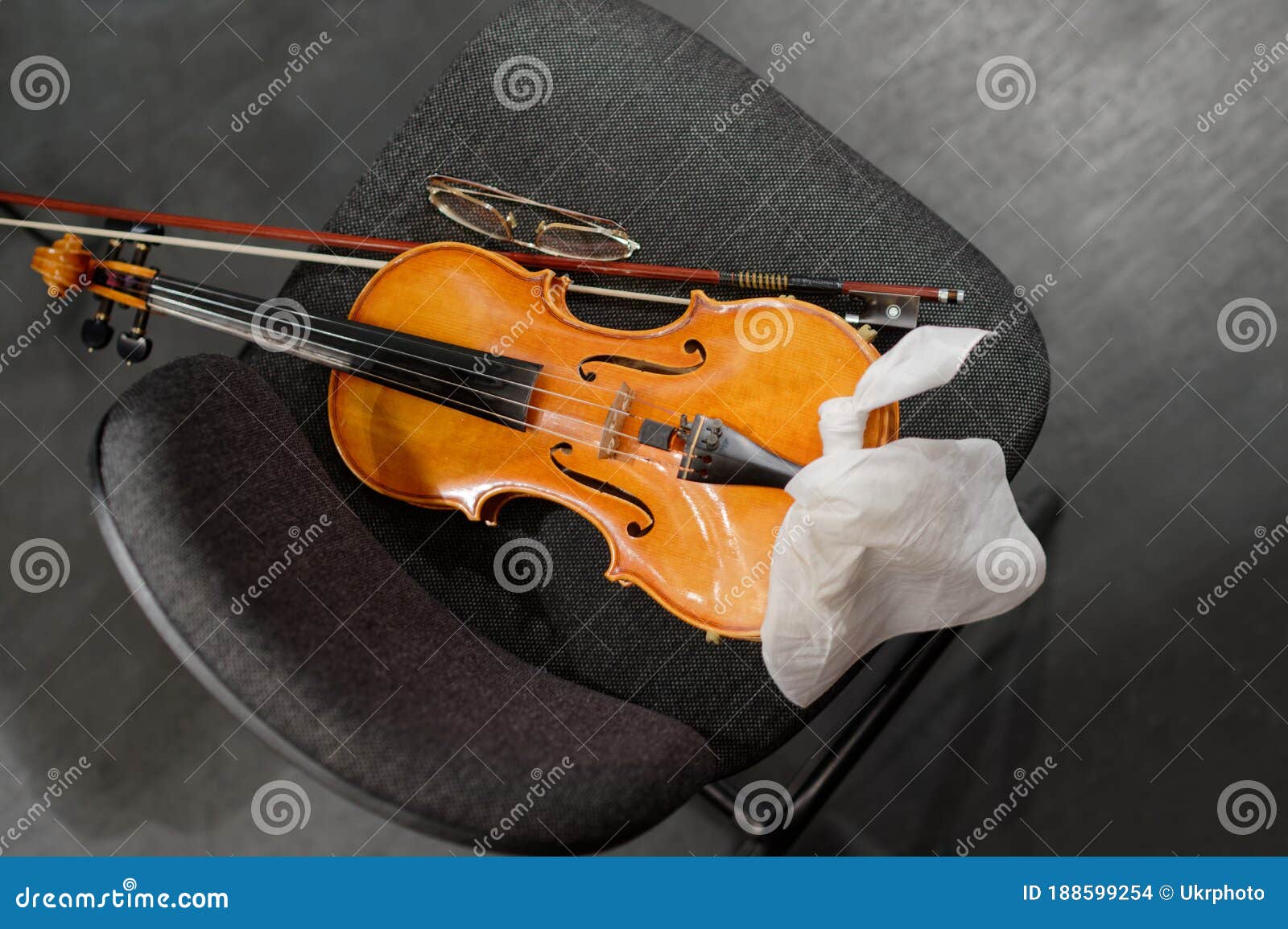 Musical Instruments Violin and Bow on the Musicians Chair Stock Photo