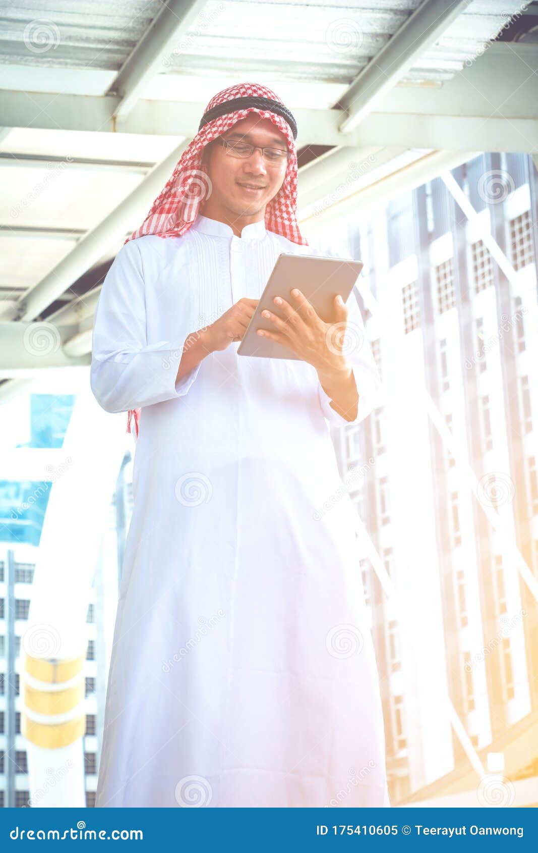 Muslim Arab Man and Smart Phone.he is Using Tablet Pc Computer and ...