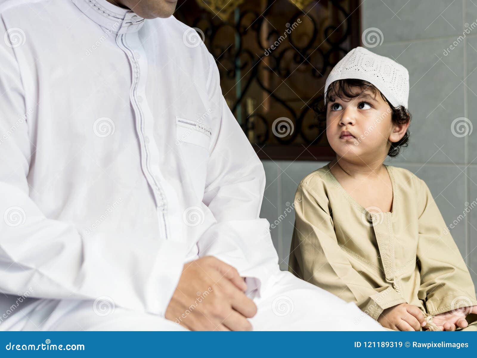 muslim boy learning how to salah