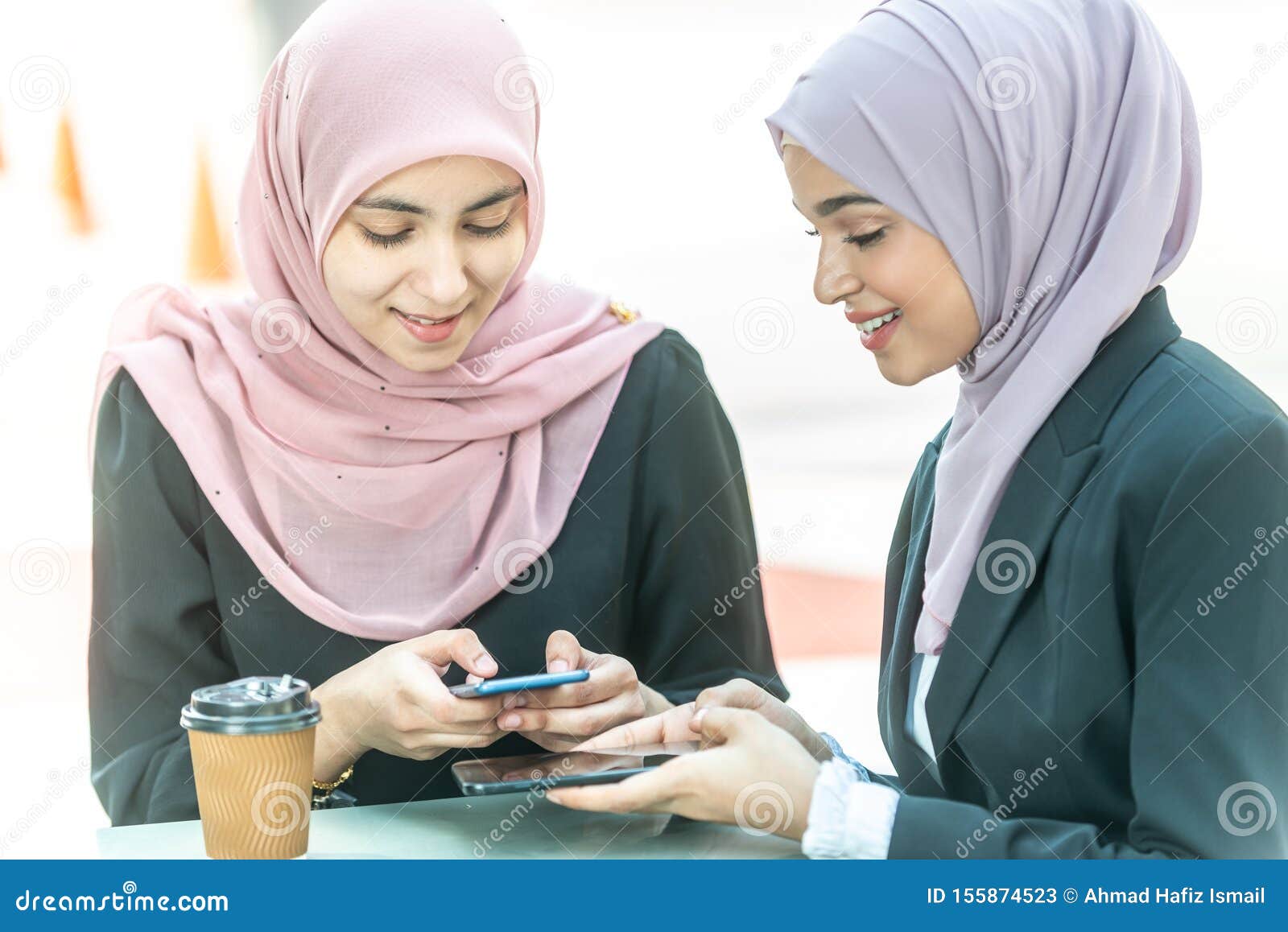 Muslim Businesswomen with Their Smartphone during Their Coffee Break ...