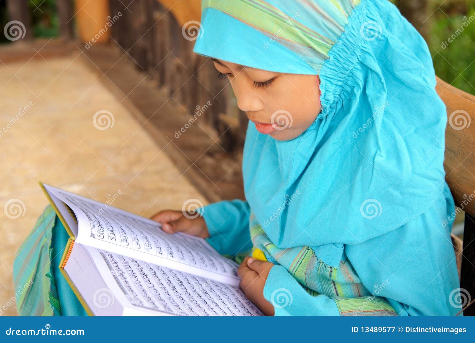 muslim child reading koran, indonesia