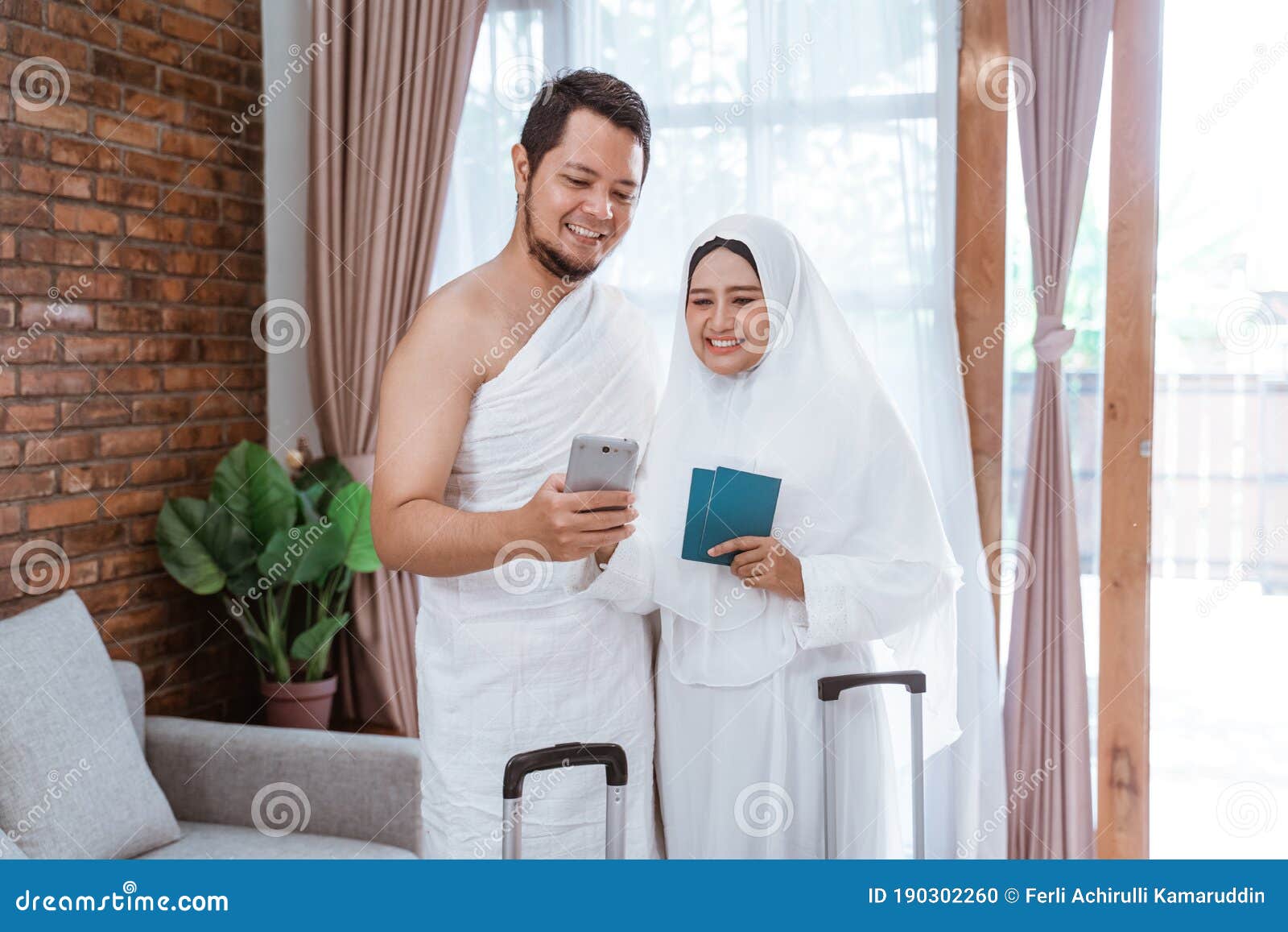 muslim couple making a phone call while umrah and hajj