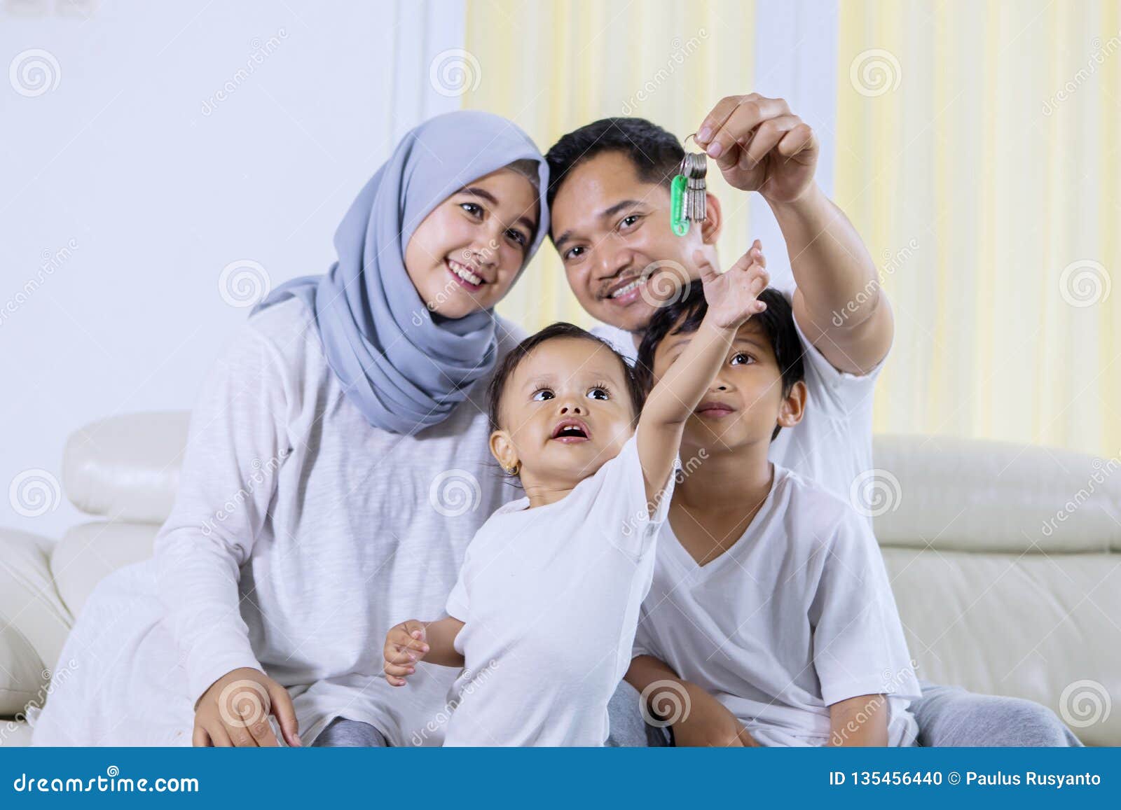 Muslim Family Holds Key To Their New Home Stock Photo - Image of living