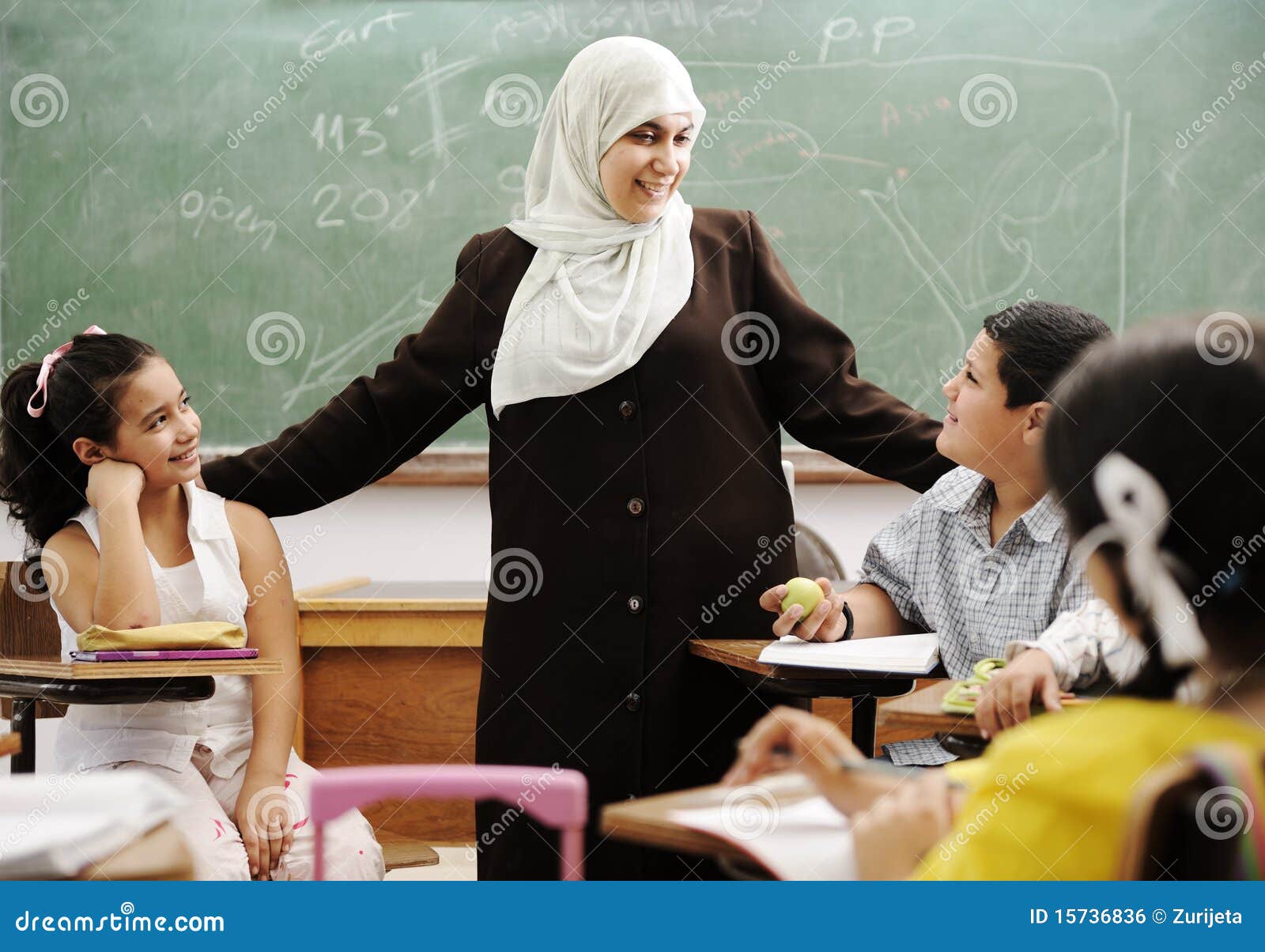 muslim female teacher with children in classroom