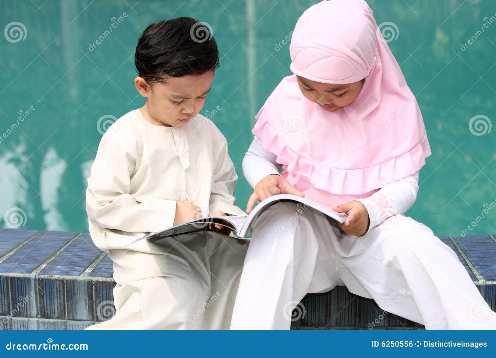 muslim kids reading a book