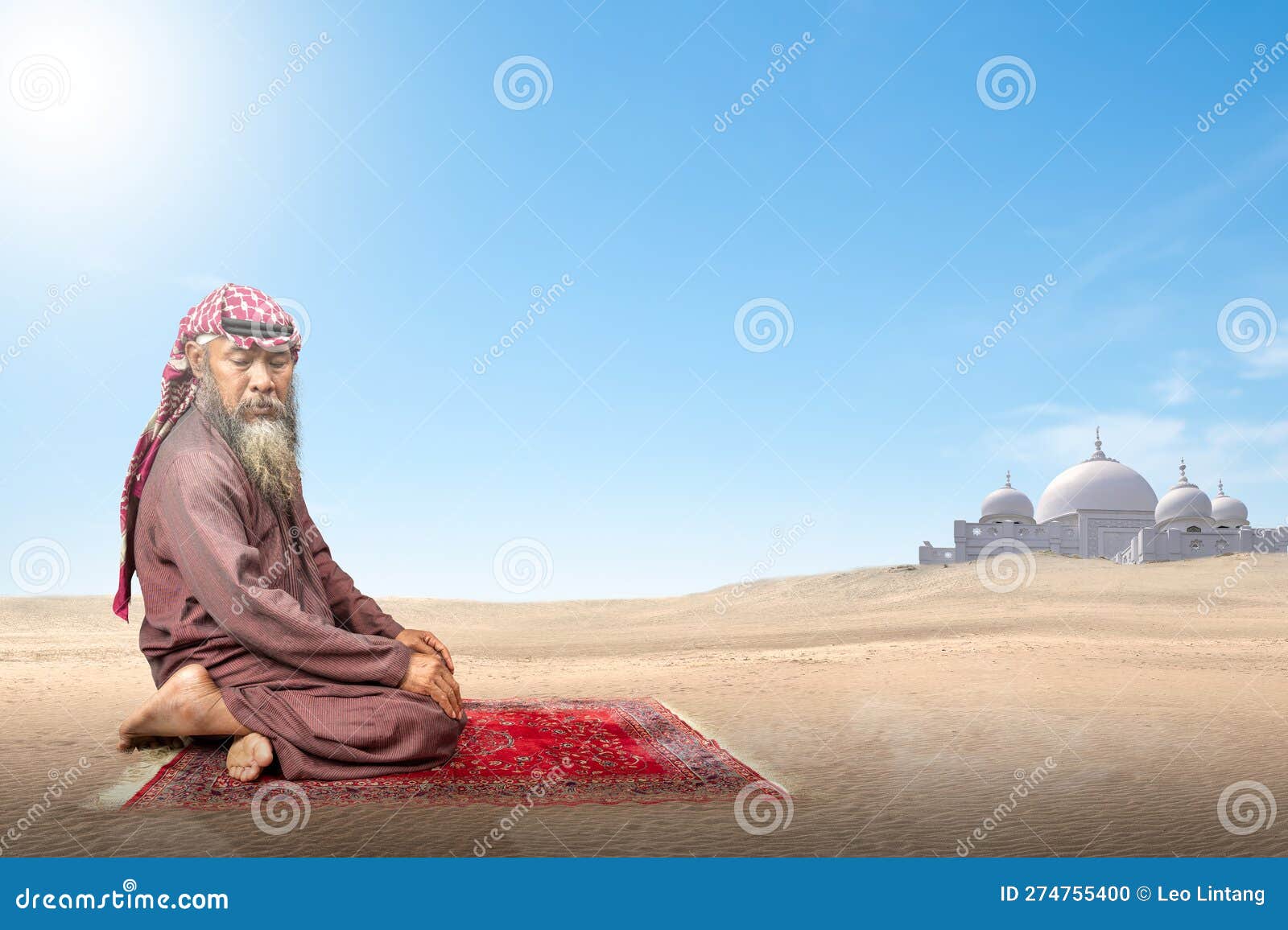 muslim man with a beard wearing keffiyeh with agal in praying position (salat) on the prayer rug