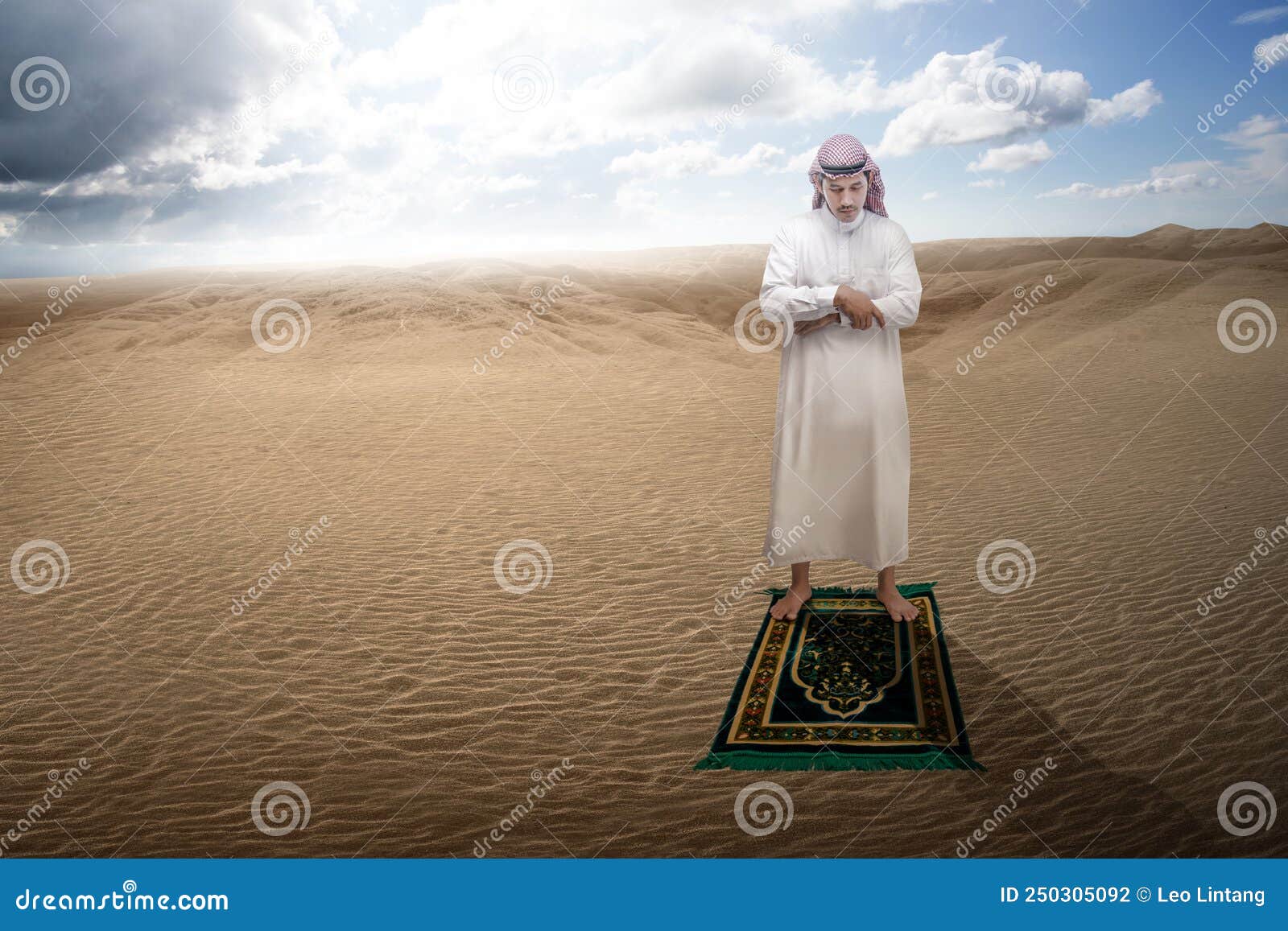 muslim man with keffiyeh with agal in praying position salat on the prayer rug