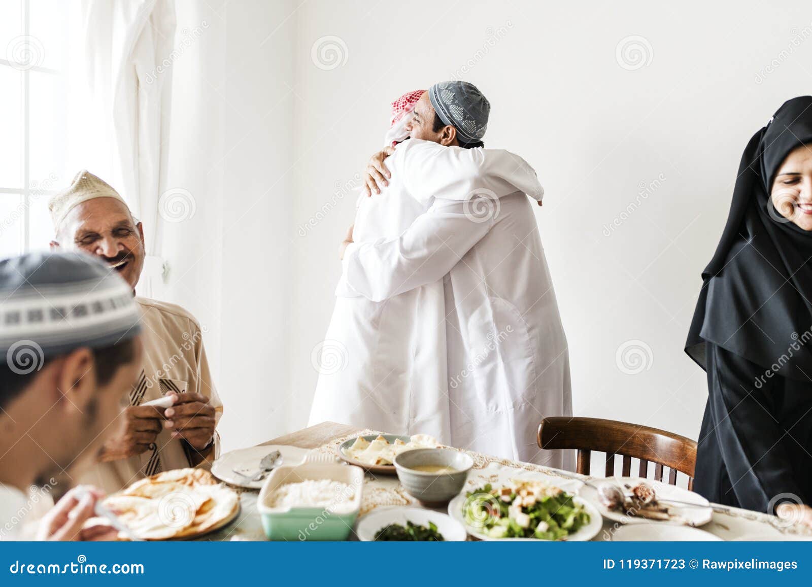 muslim men hugging at lunchtime