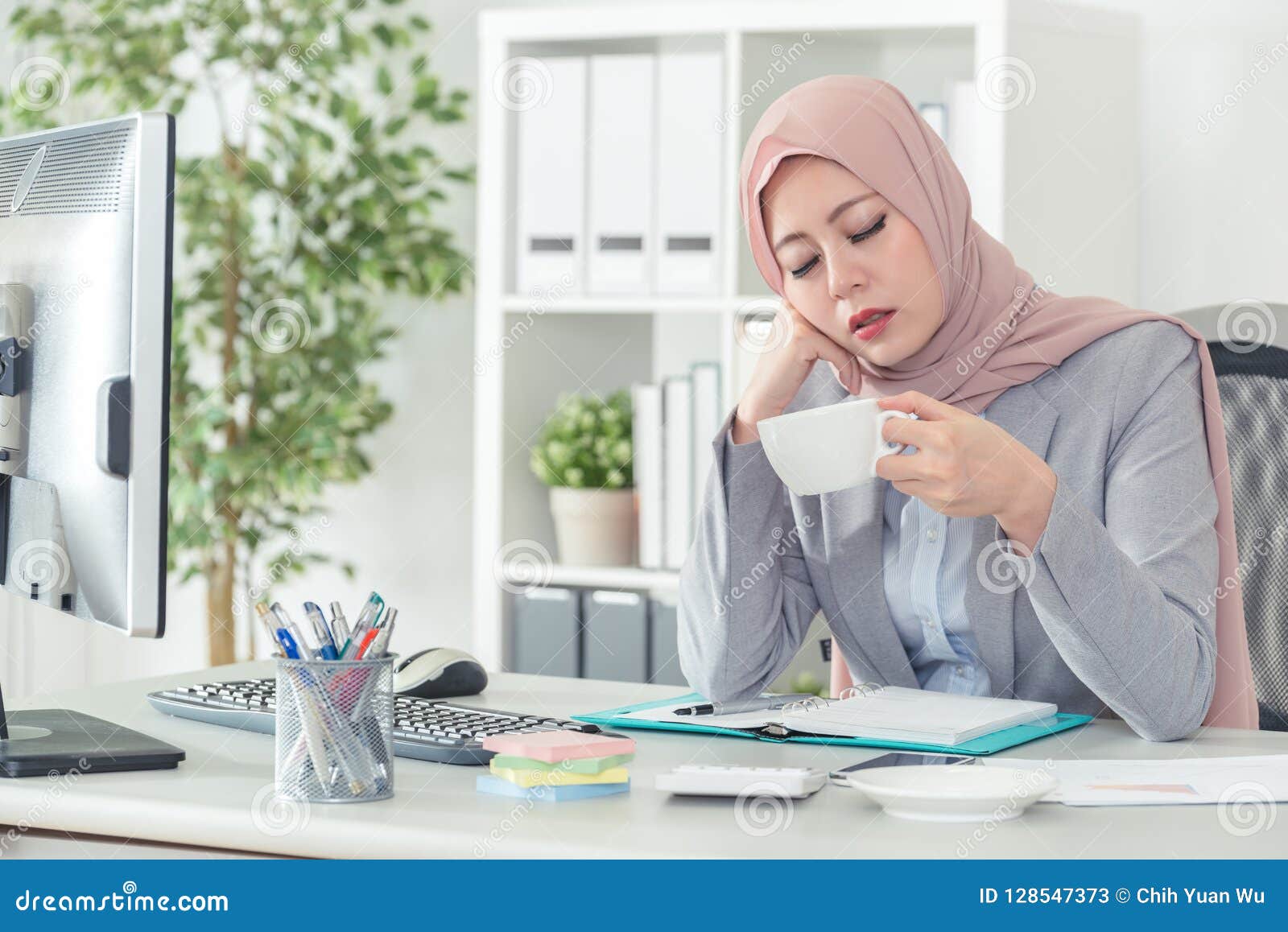 Muslim Office Lady Falling Asleep At Office Desk Stock Image