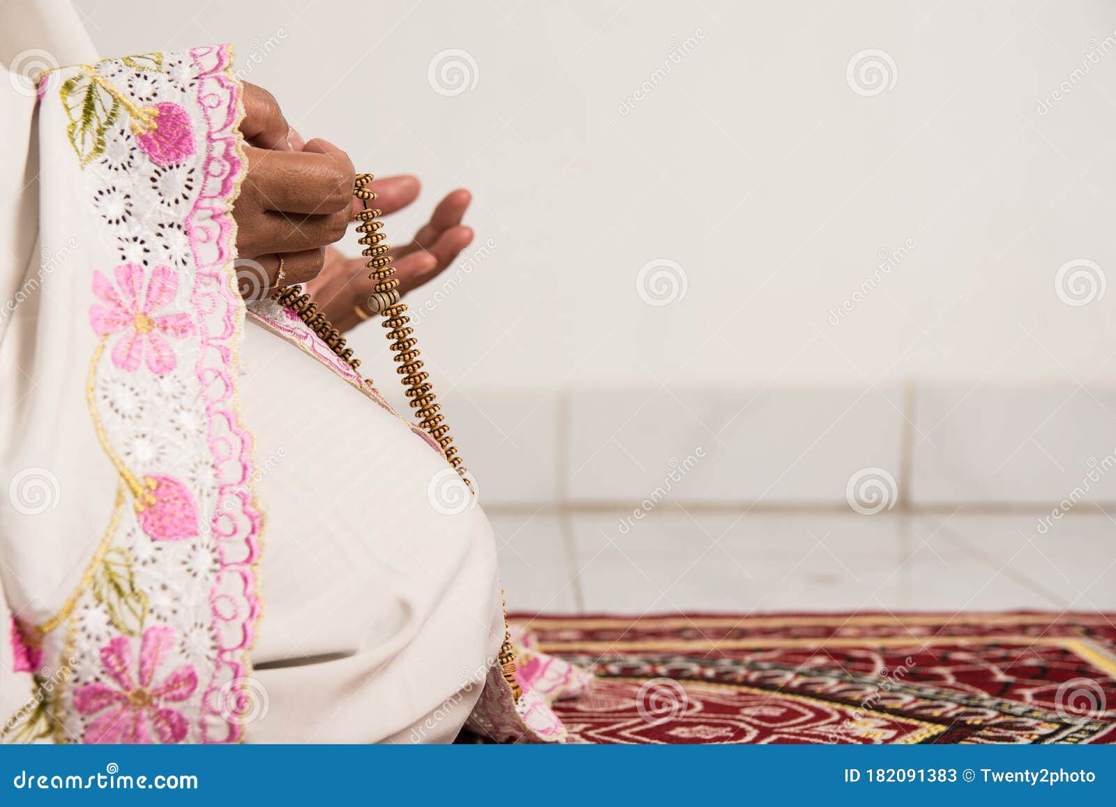 muslim woman praying close up image of hands as she holds prayer beads,tasbih