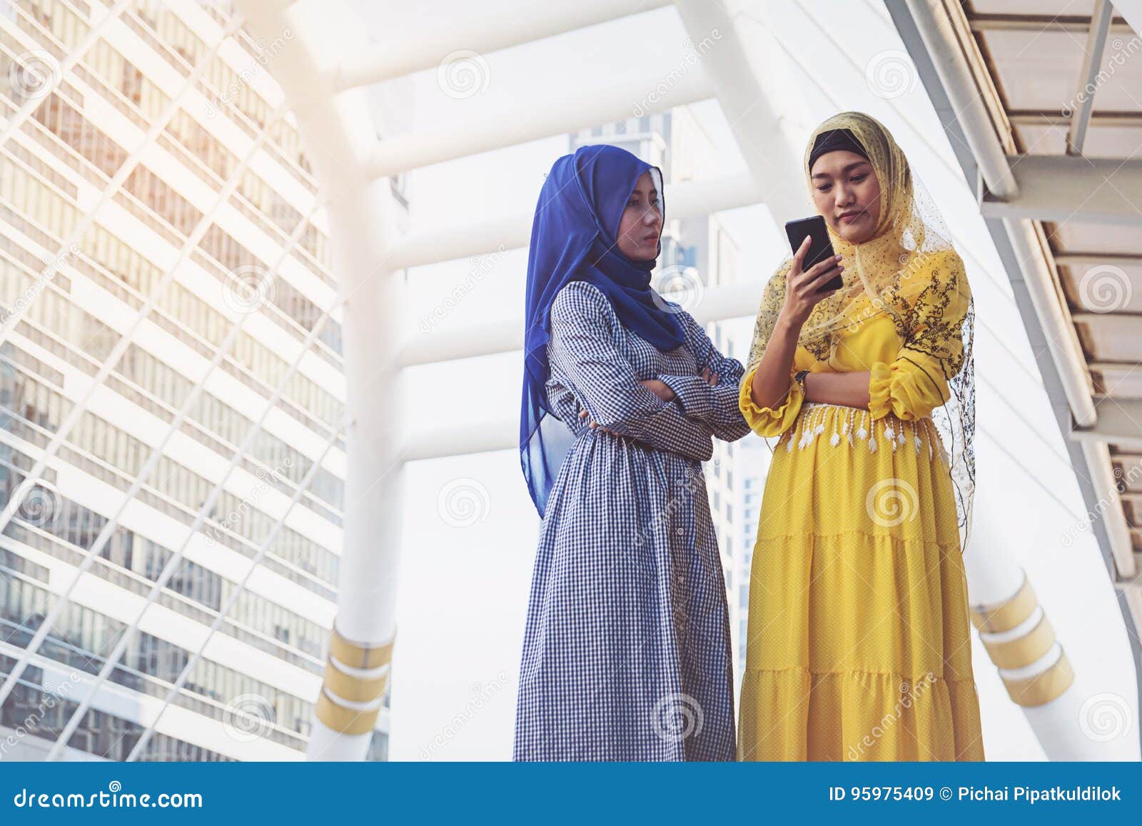 Muslim Women Messaging on a Mobile Phone in the City Stock Image ...