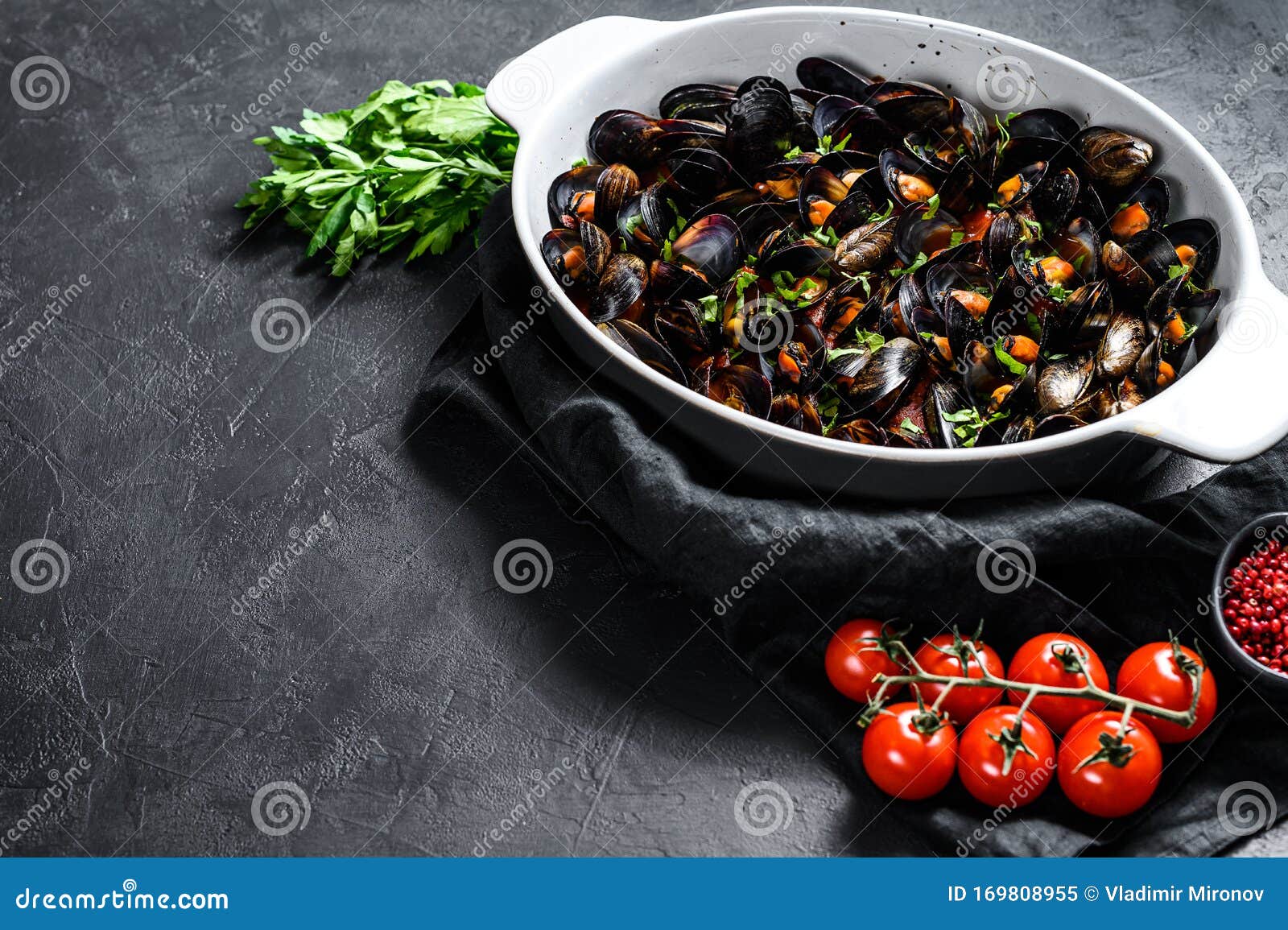 mussels in tomato sauce with parsley and  herbs. black background. top view. space for text