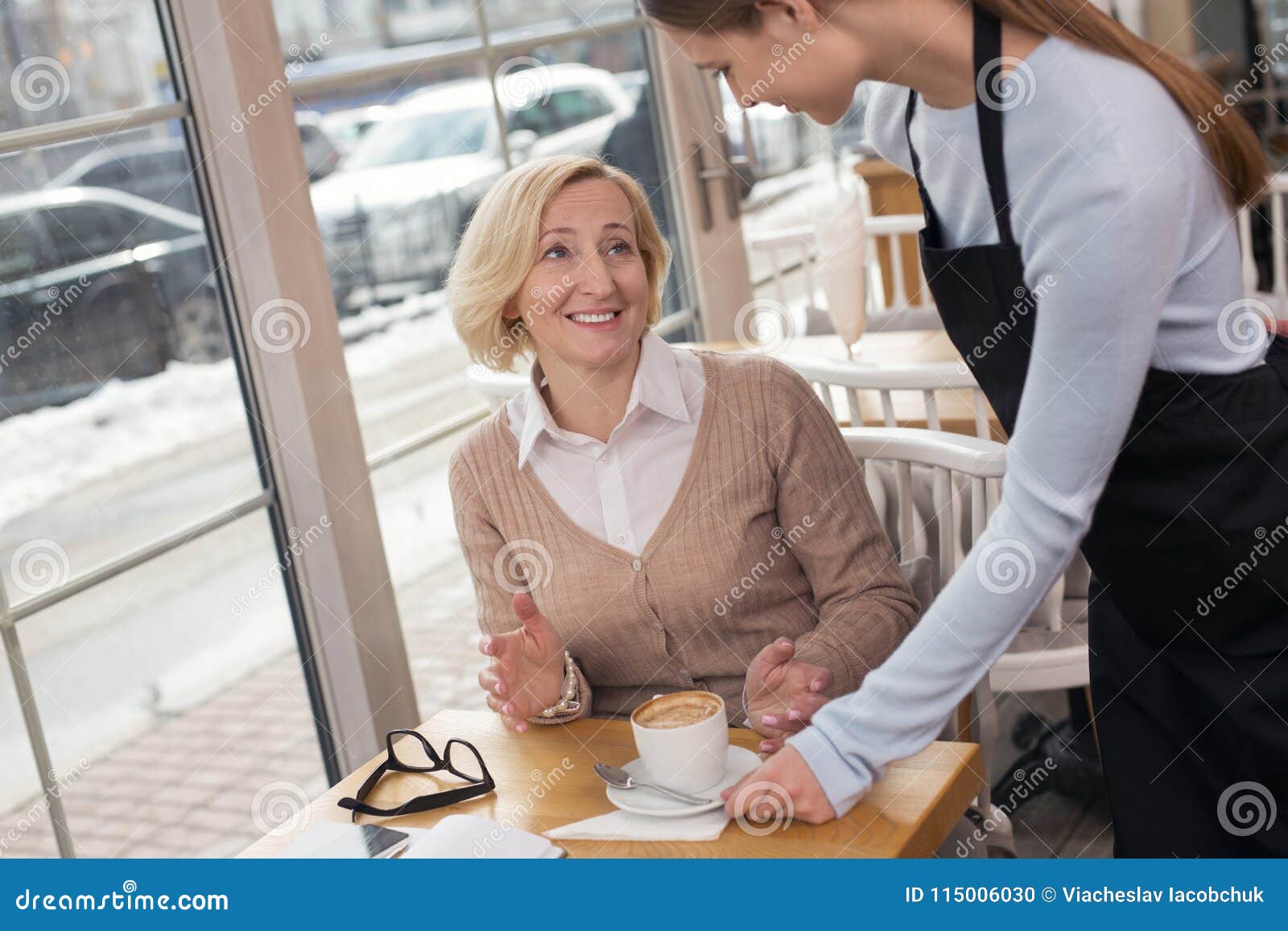 happy woman drinking coffee in a cafe