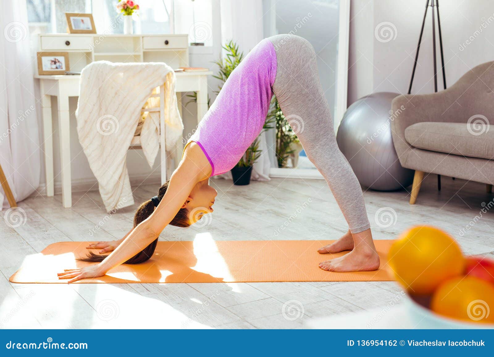 Pleasant Slim Woman Standing on the Yoga Mat Stock Photo - Image