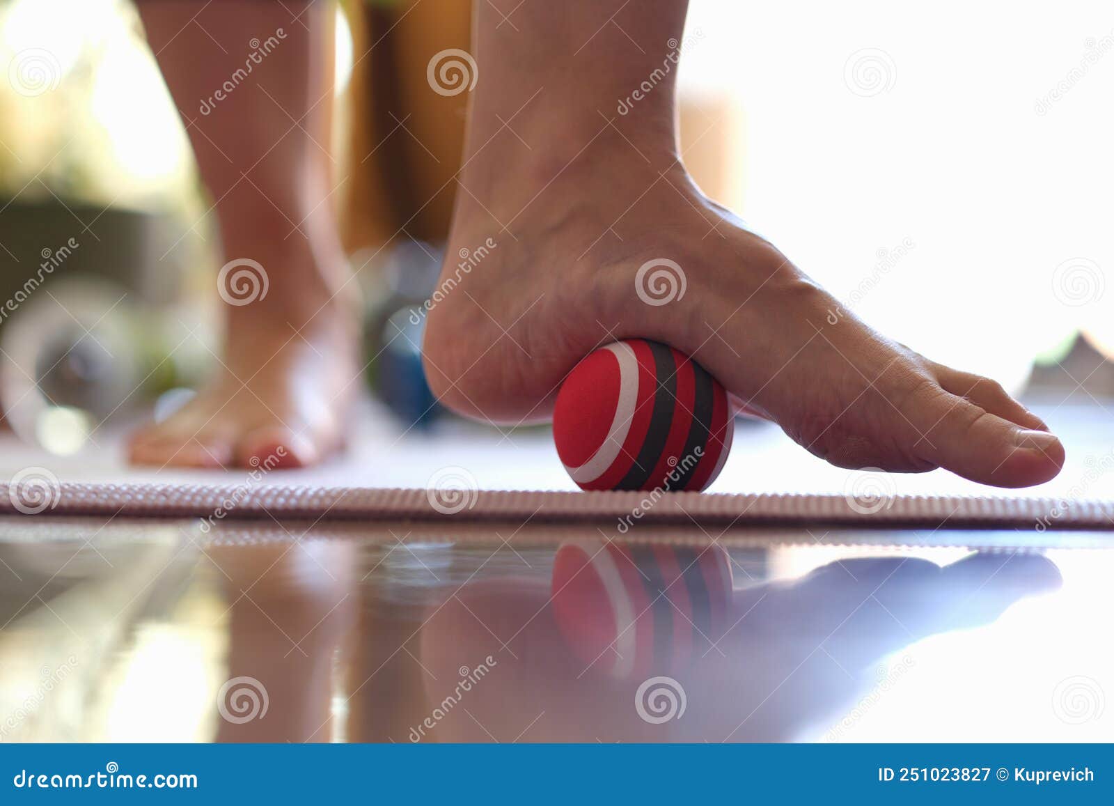 myofascial relaxation of hypermobile muscles of foot with a massage ball closeup