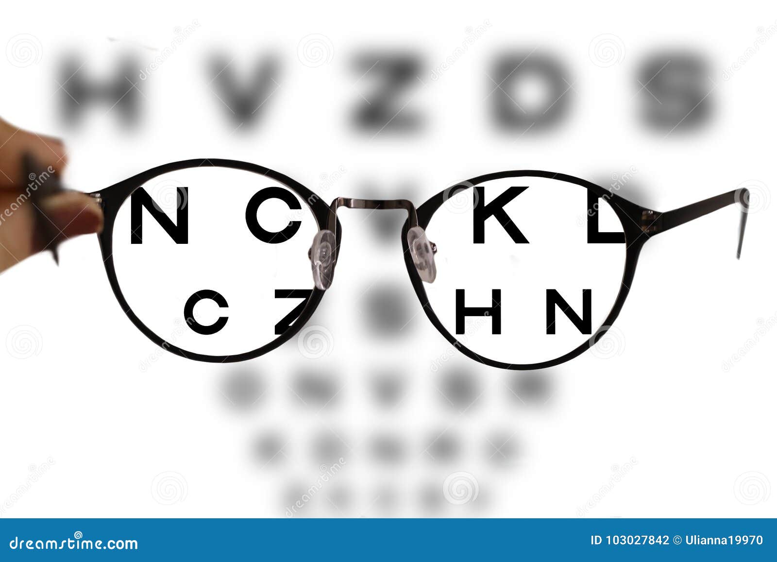 myopia correction glasses on the eye chart letters