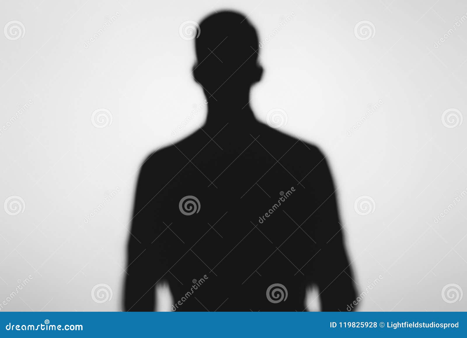 mysterious blurry shadow of spooky person standing on grey