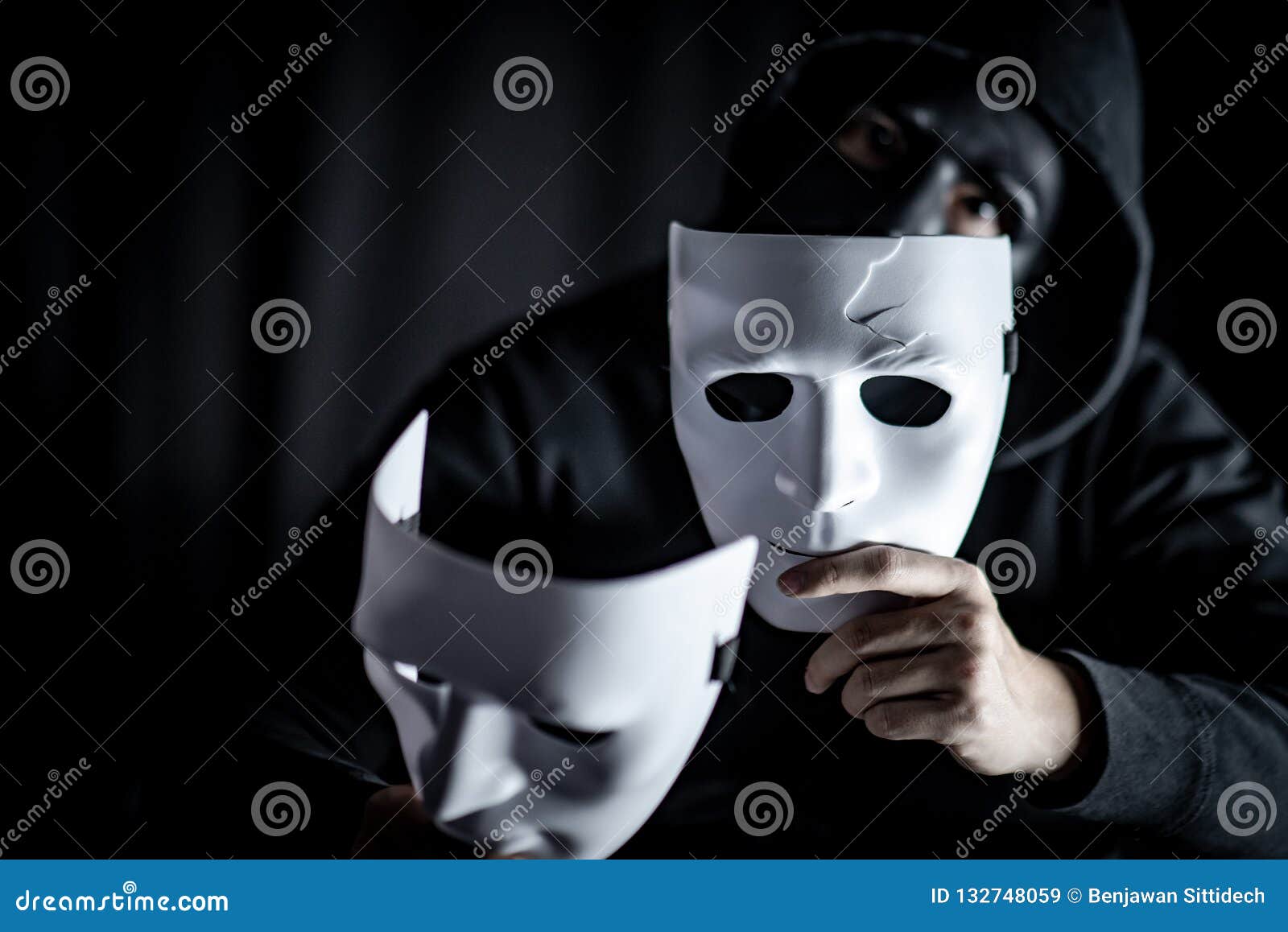 Mystery Man in Black Mask Holding White Masks Stock Image - Image