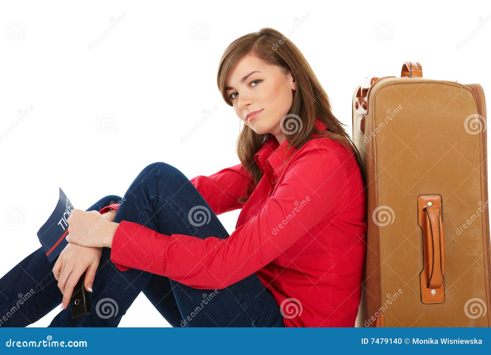 Mädchen, das nahe einem Koffer sitzt. Touristisches Mädchen, das nahe einem Koffer mit einer Karte in ihrer Hand sitzt