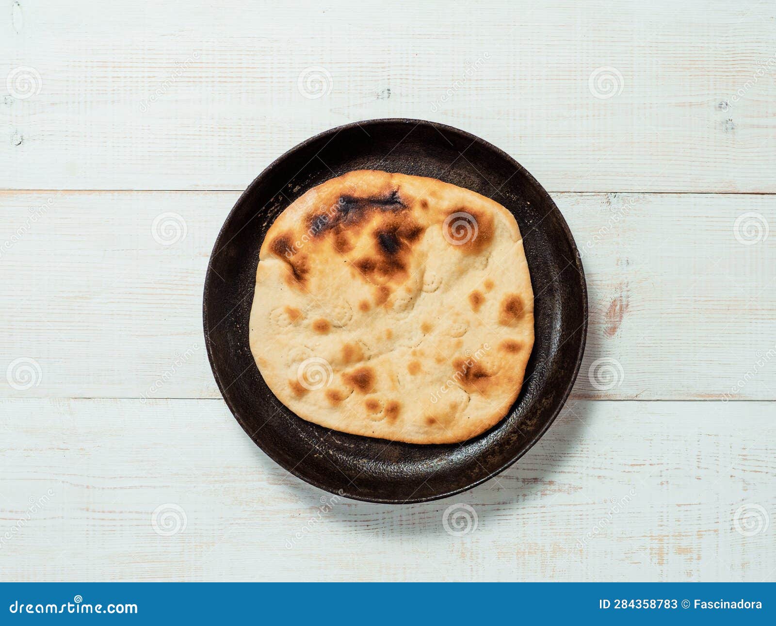 naan flatbread on white wood, copy space, top view