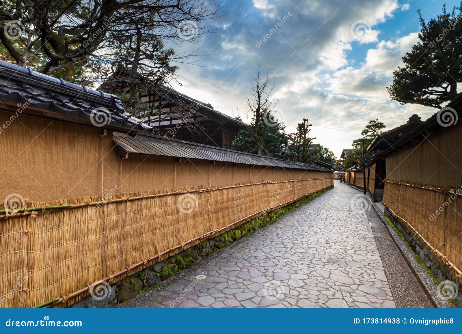 nagamashi district or samurai district street with dramatic sky showing the earthen walls covered with straw mats, kanazawa, japan