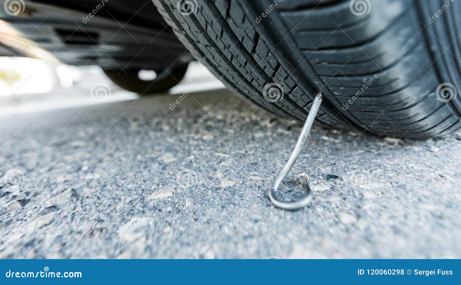Nail on an Asphalt Road with a Car. Stock Photo Image of motorcycle
