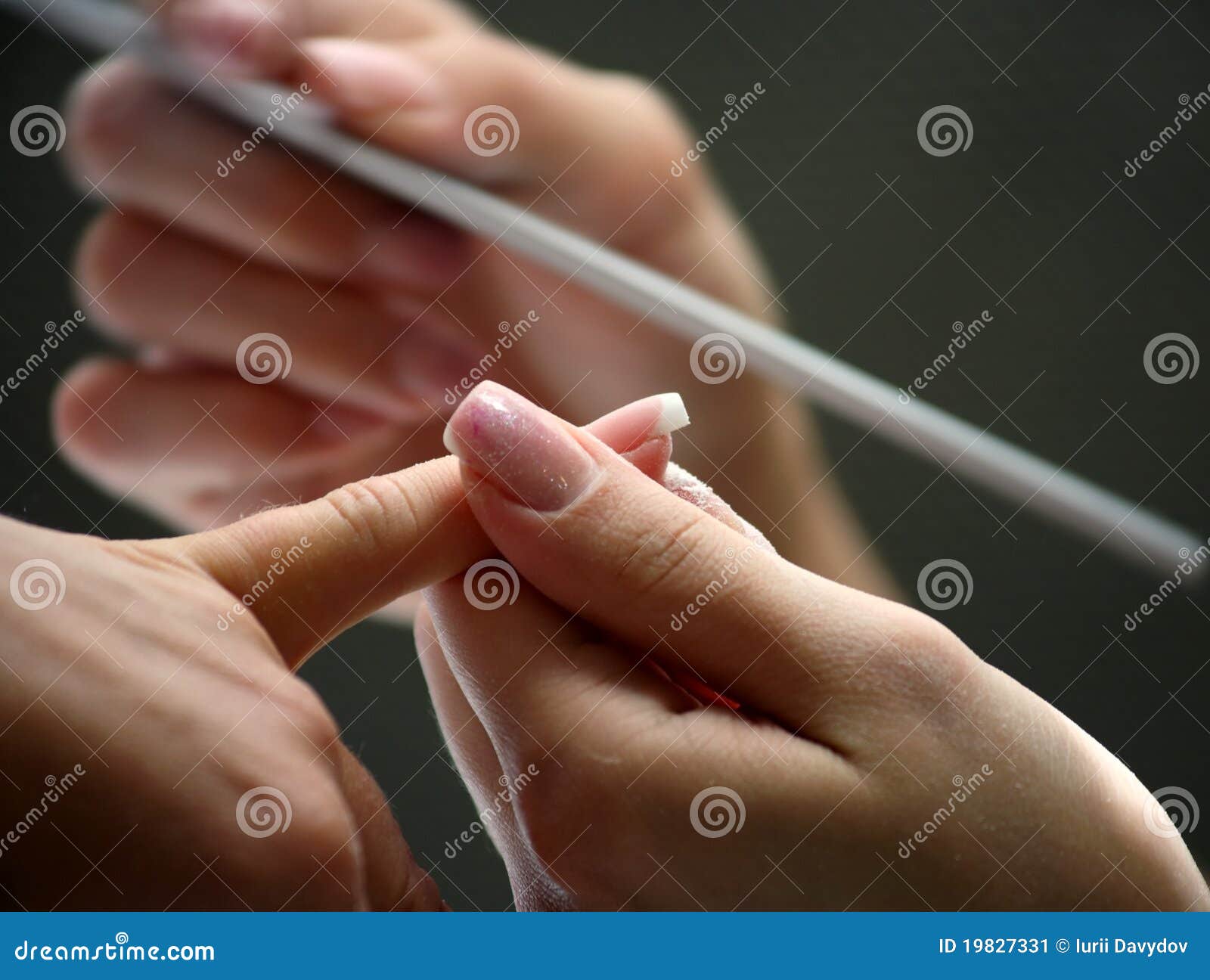 nail beautician polishing nails