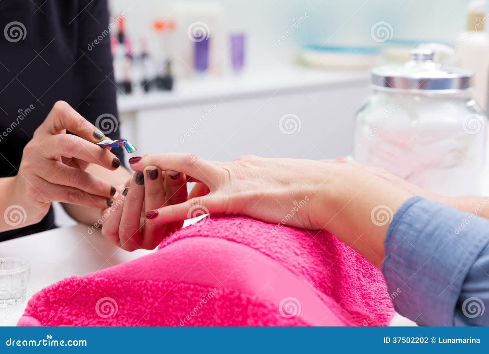 nail saloon woman with hand manicure cuticle scraper pusher