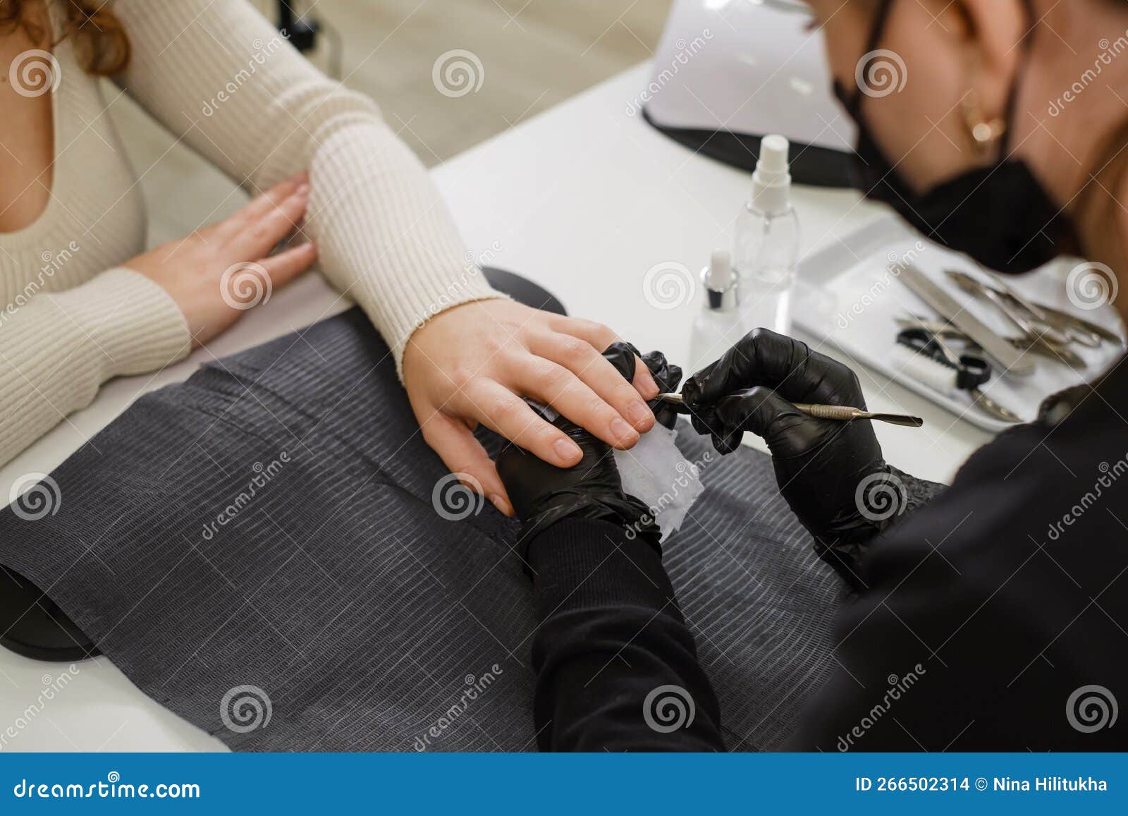 nail service. cropped view of the girl getting her nails done at the salon