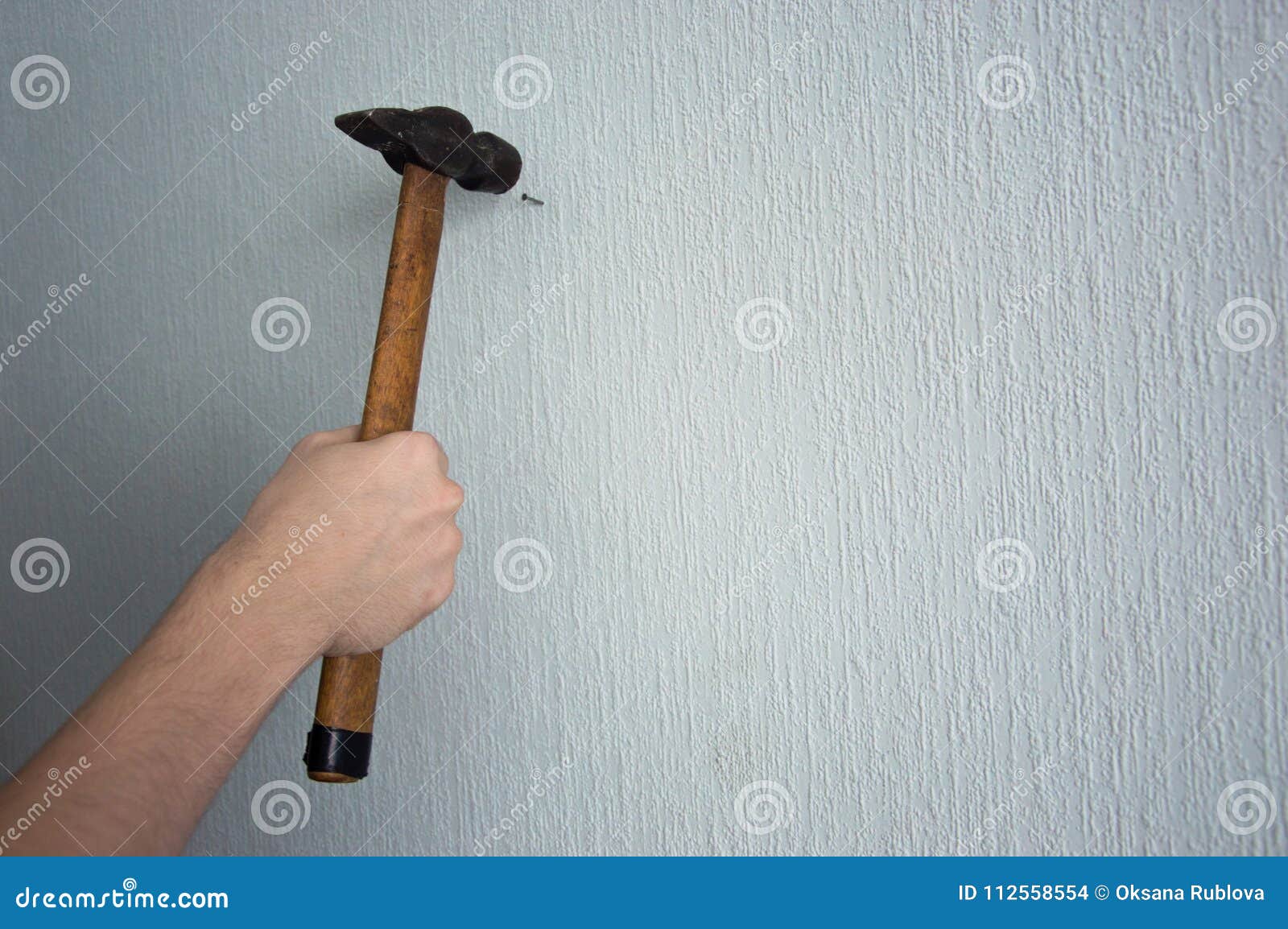 Knocking a Nail into the Wall with a Hammer Stock Photo - Image of building, hammer: 112558554 Knocking a Nail into the Wall with a Hammer Stock Photo - Image of building, hammer: 112558554