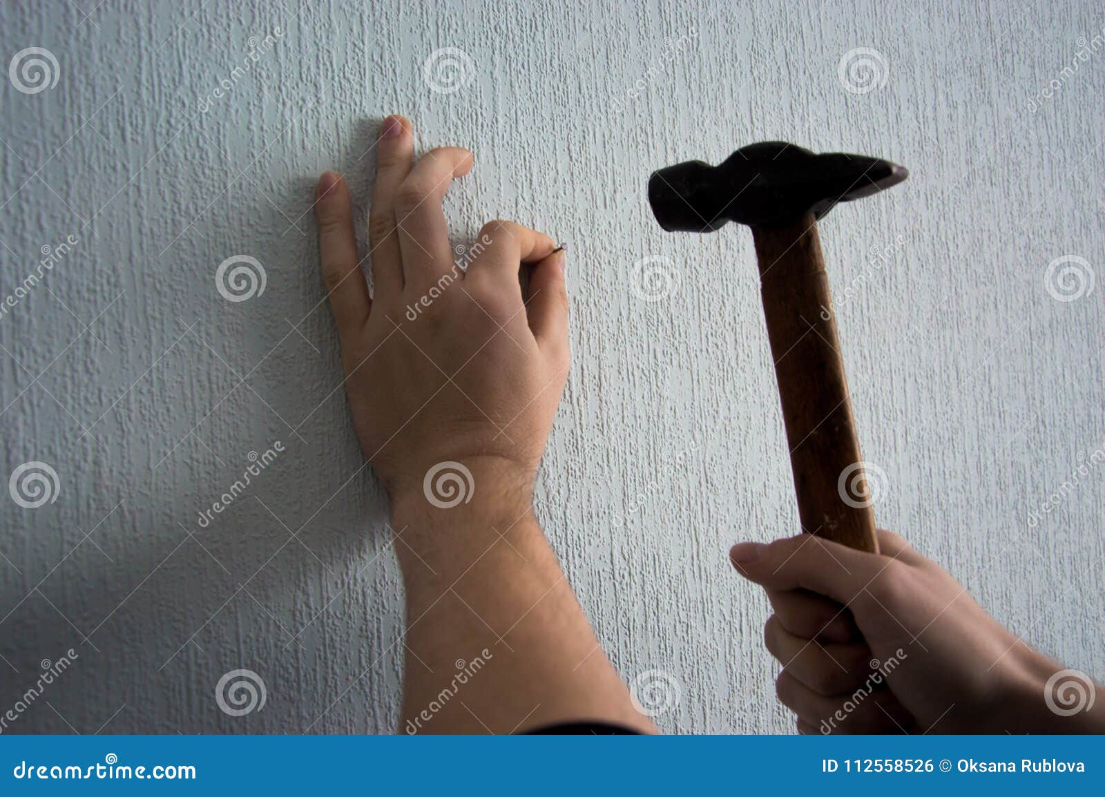 Knocking a Nail into the Wall with a Hammer Stock Photo - Image of  building, employee: 112558526