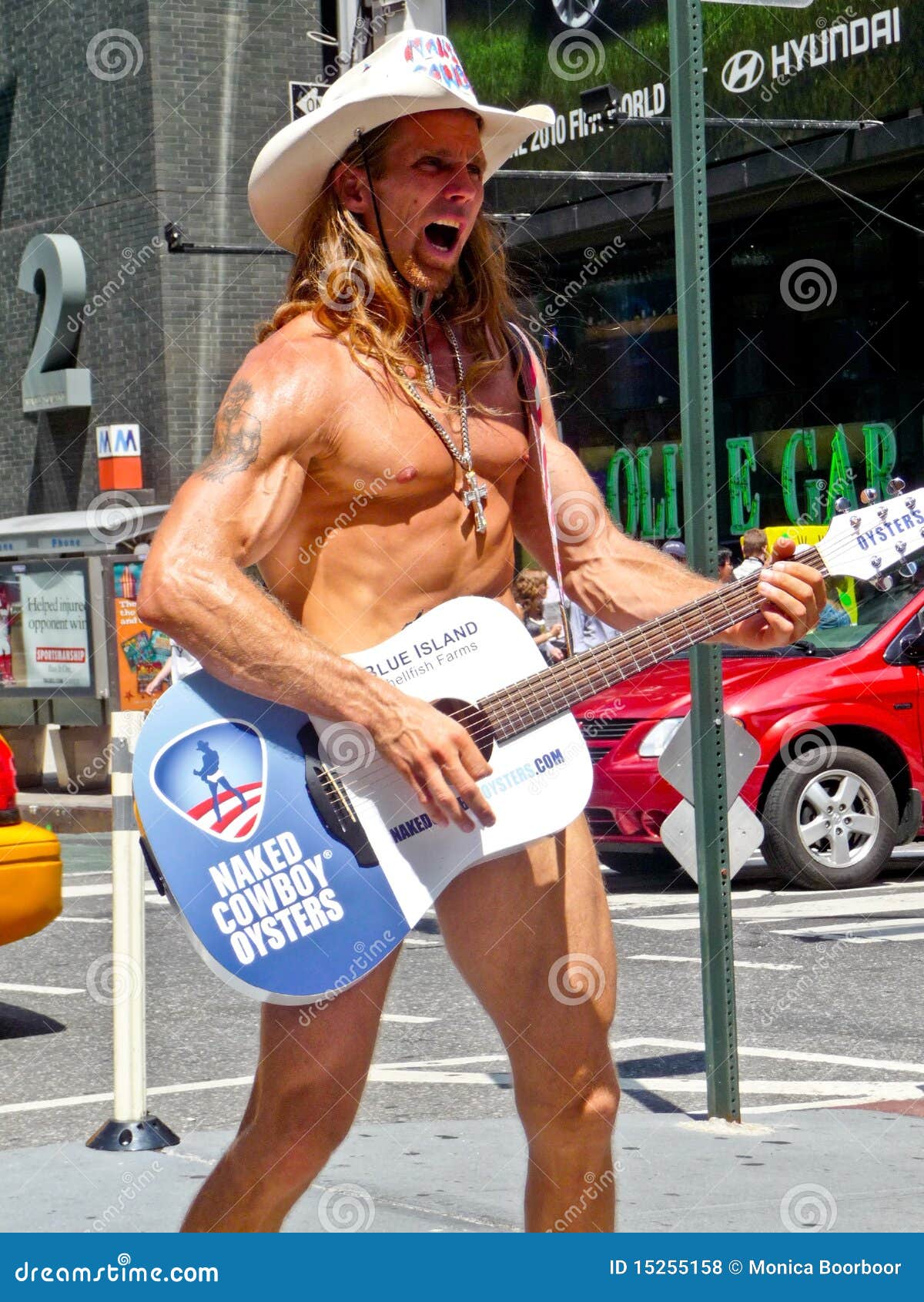 Naked Cowboy singing. Famous naked singing cowboy with guitar in Times Square New York enetertaing the people in his underwear.