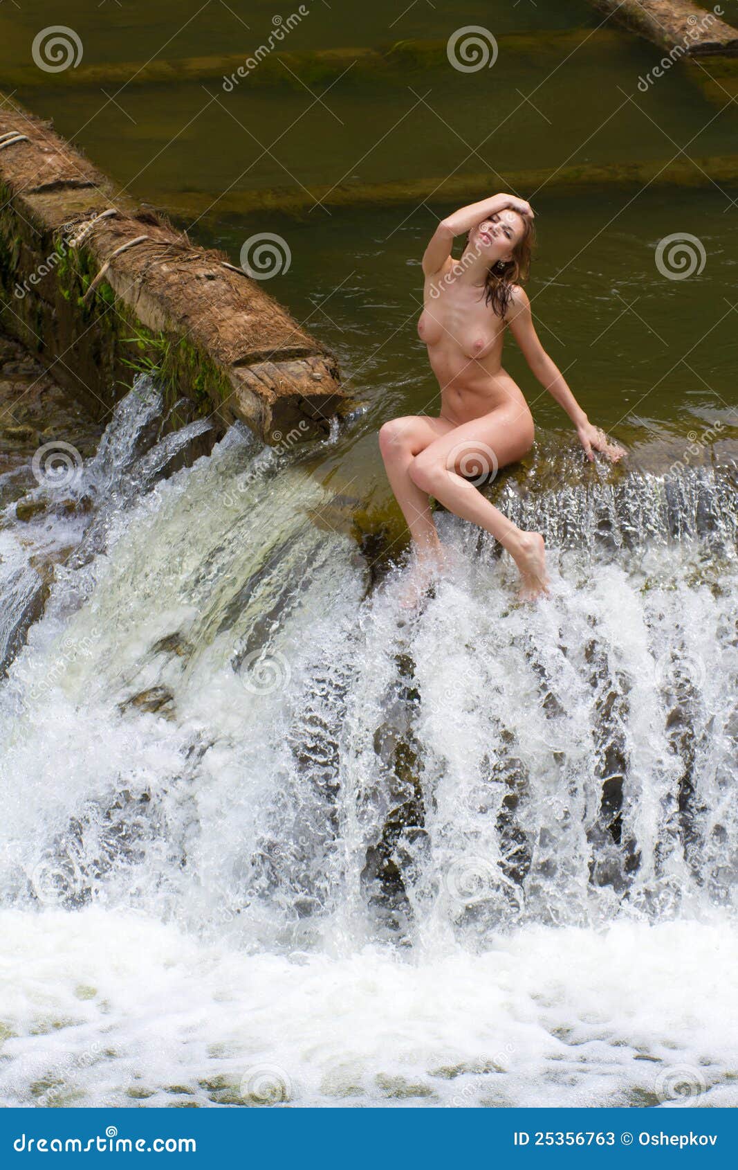 Naked Girl Sitting by a Waterfall
