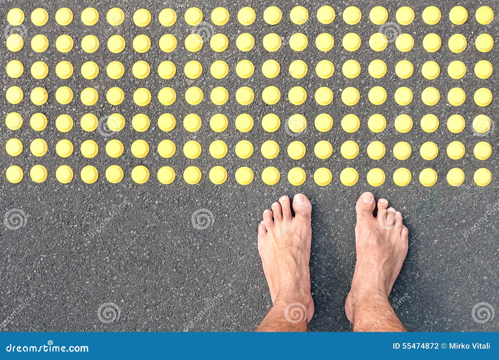 naked human barefoot on asphalt road at tactile bumps pavin