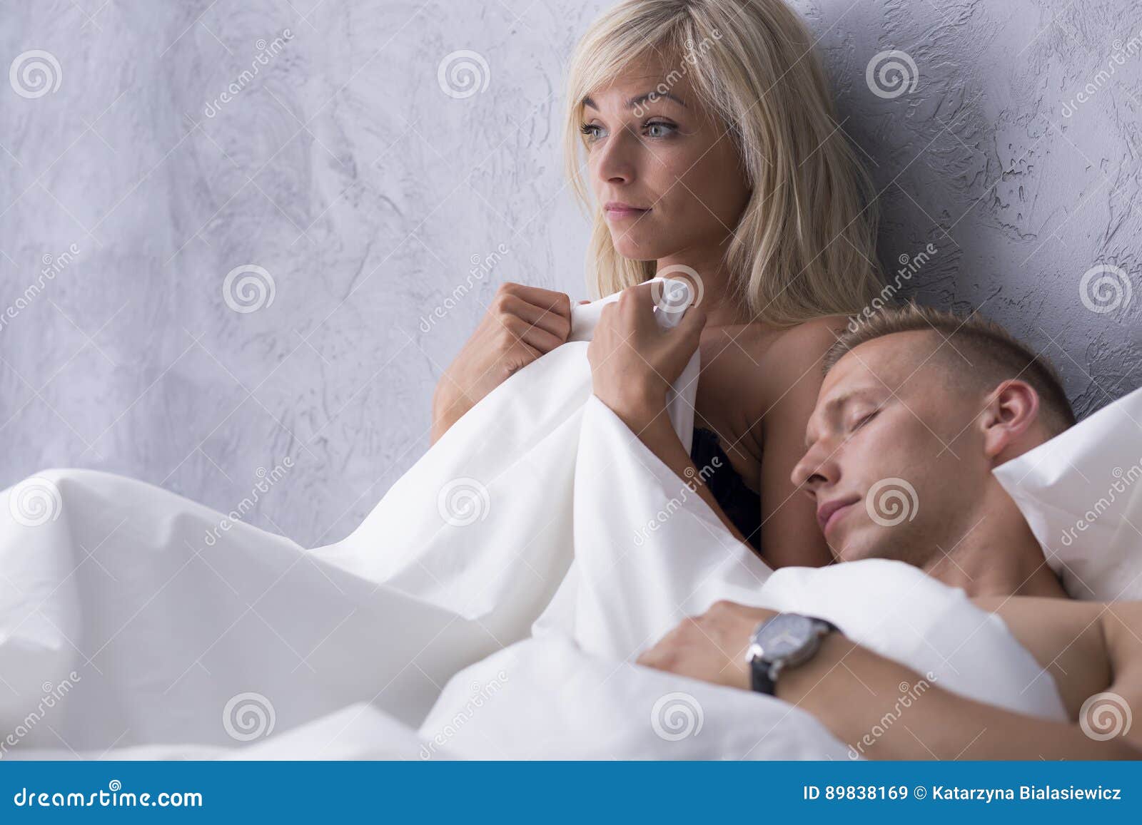 Naked man and woman in bed stock image photo