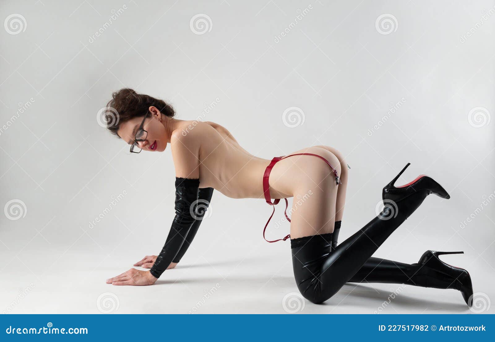 The Naked Woman in Latex Stockings and Gloves Bdsm Mistress for Sex Games on the Floor on Her Knees Stock Photo