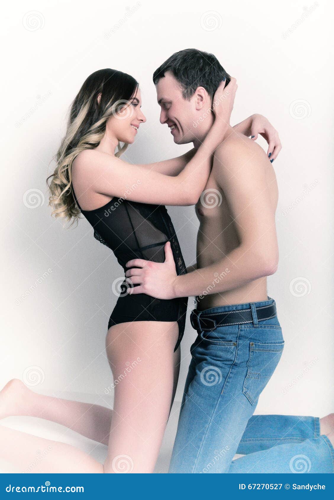 Naked Woman and a Man Kneeling and Tenderly Looking at Each Other Stock Image