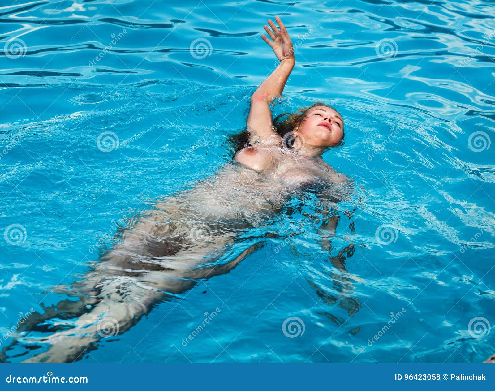Nude woman swimming