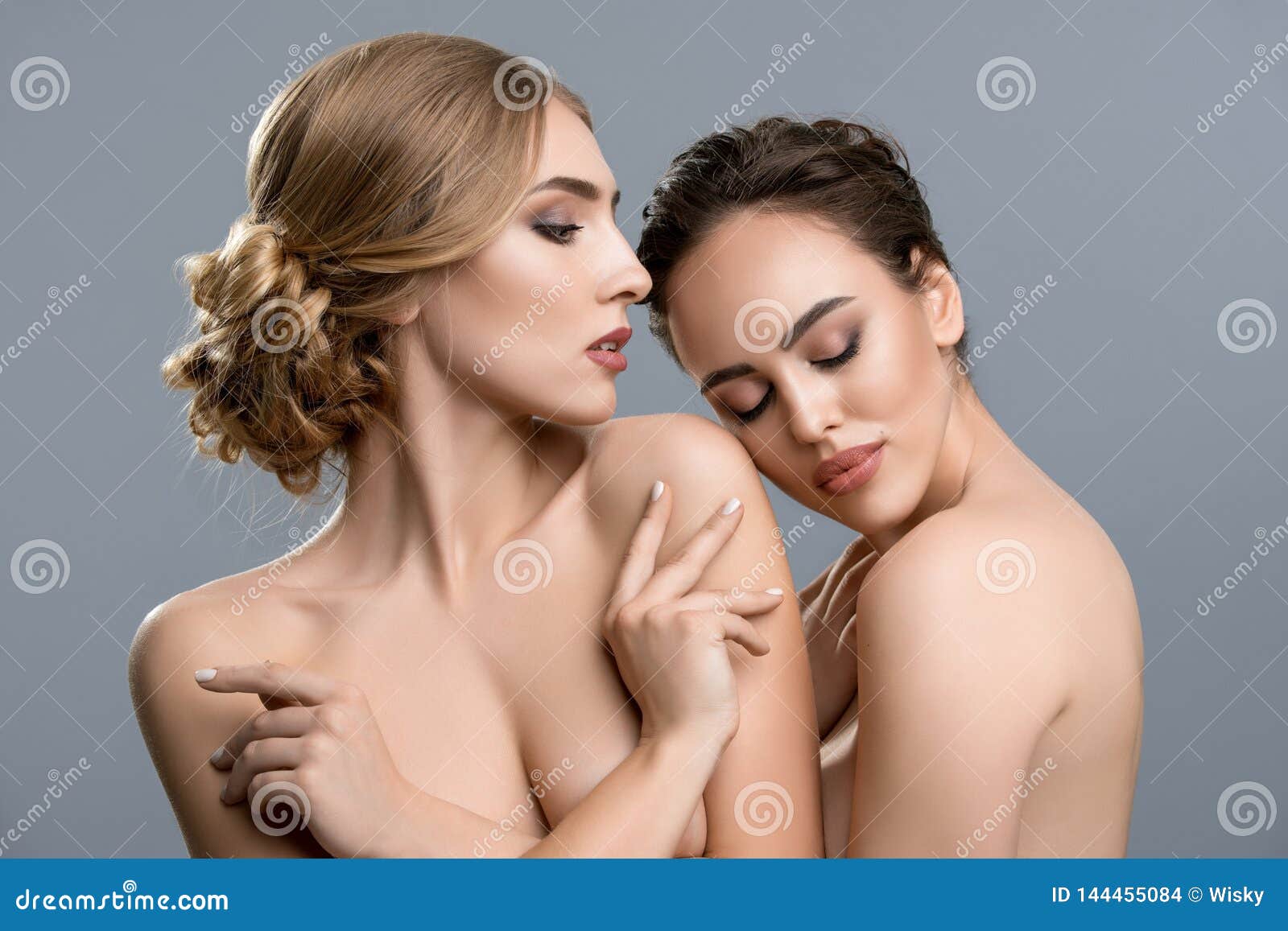 Naked women touching each other