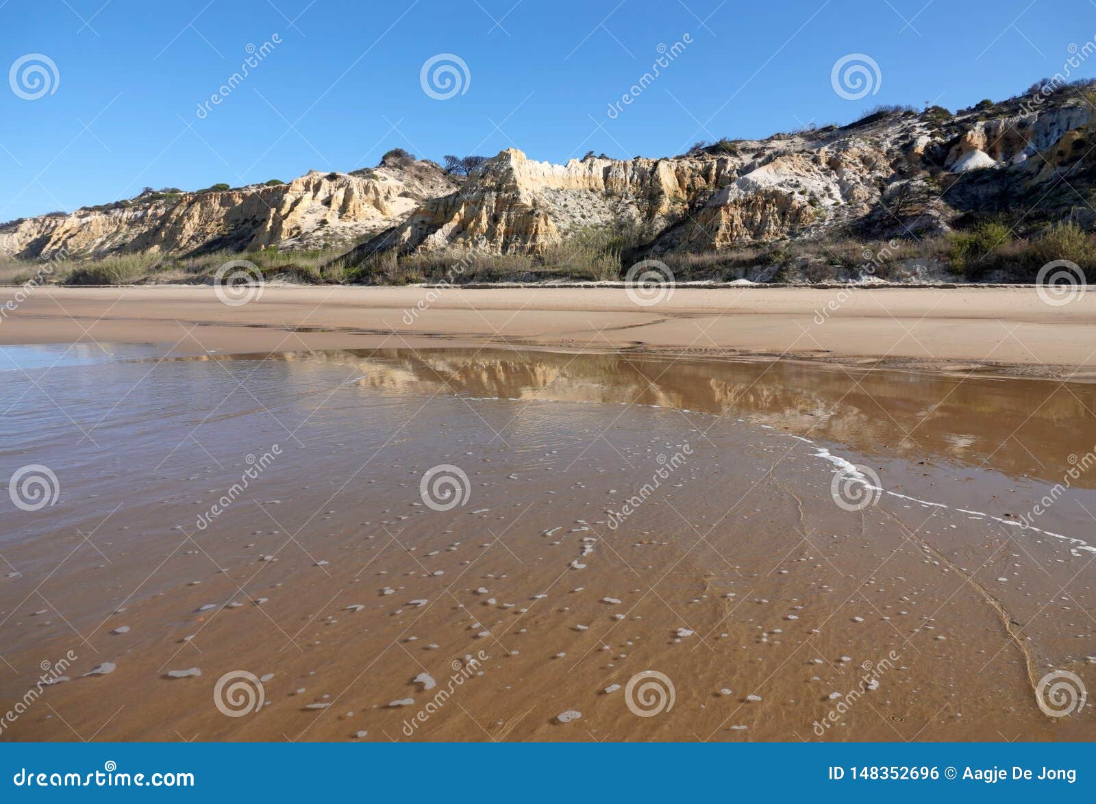 colourful dunes of playa de rompeculos beach in mazagon, spain