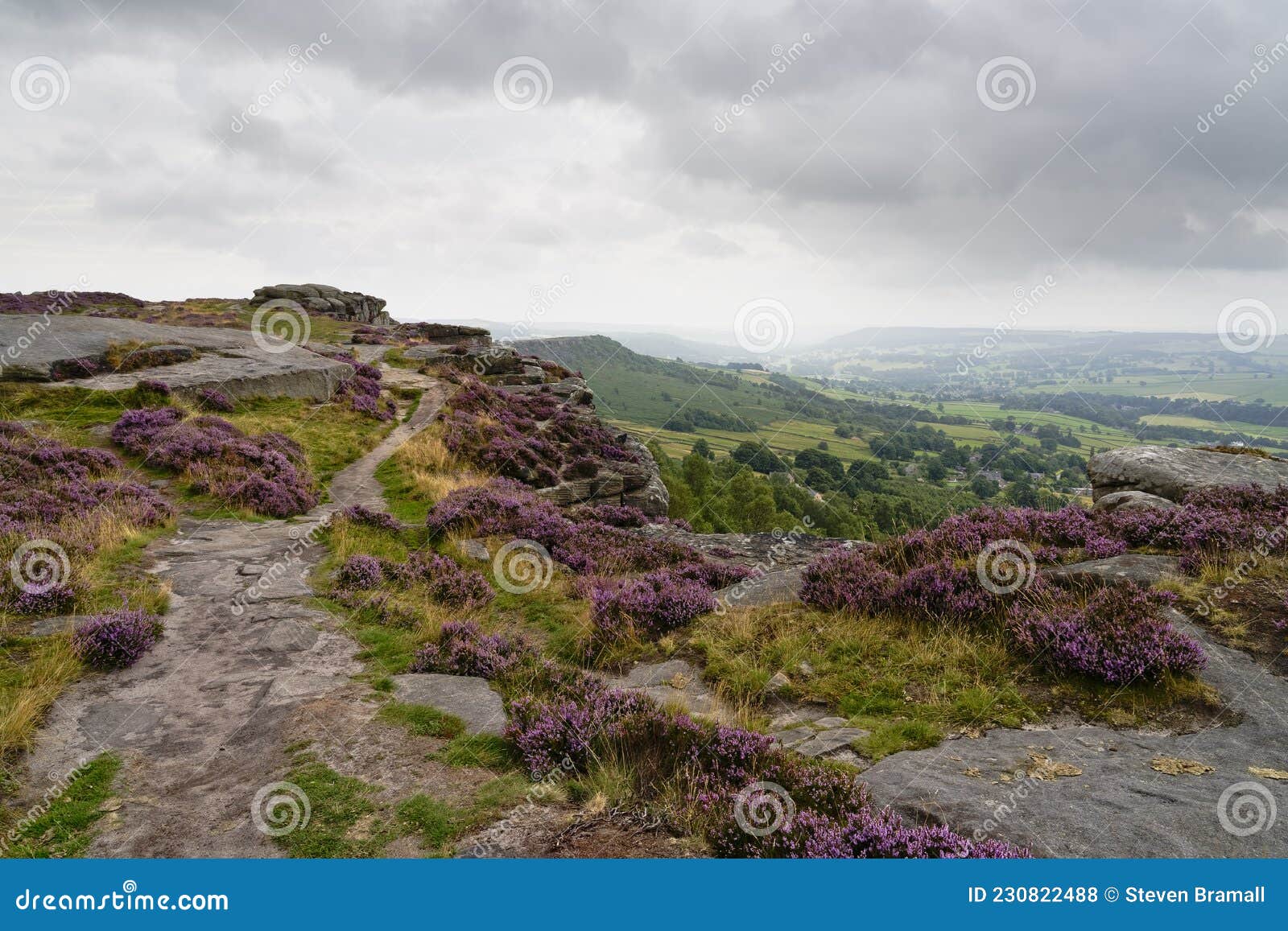 narrow footpath runs precariously close to the edge of curbar edge on a damp grey summer morning