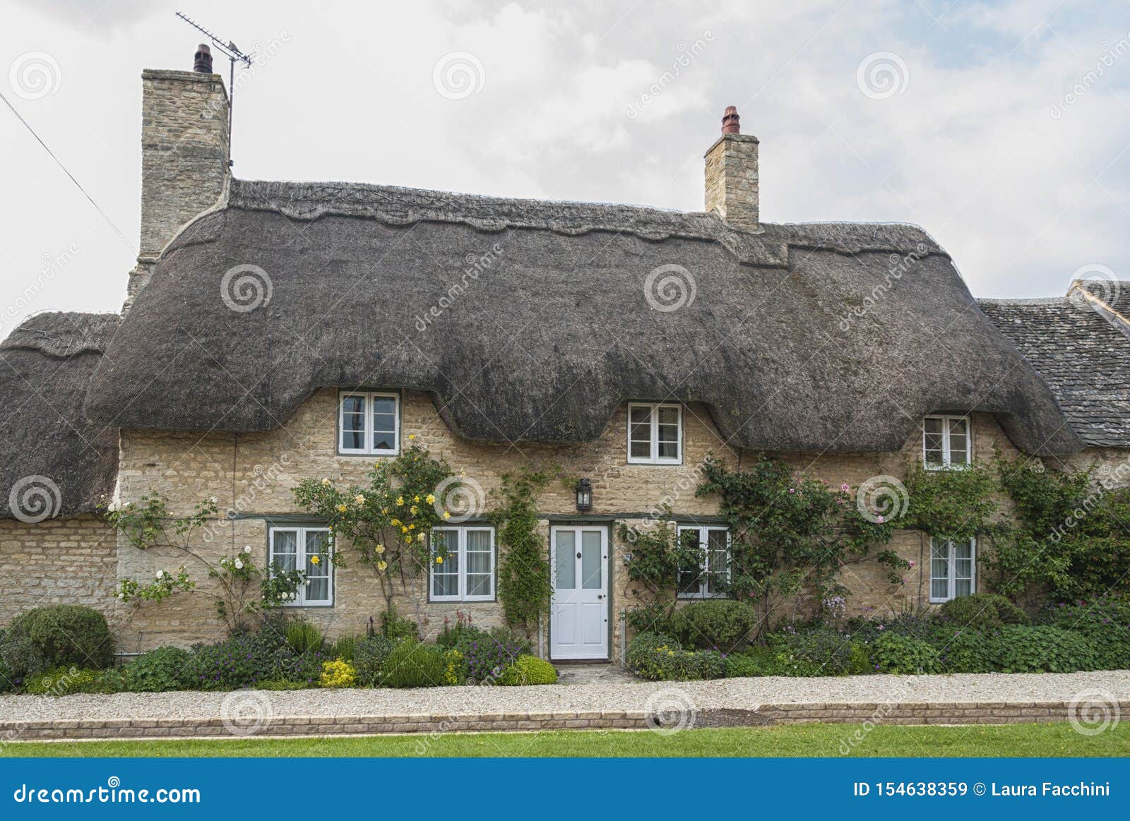Narrow Lane With Romantic Thatched Houses And Stone Cottages In