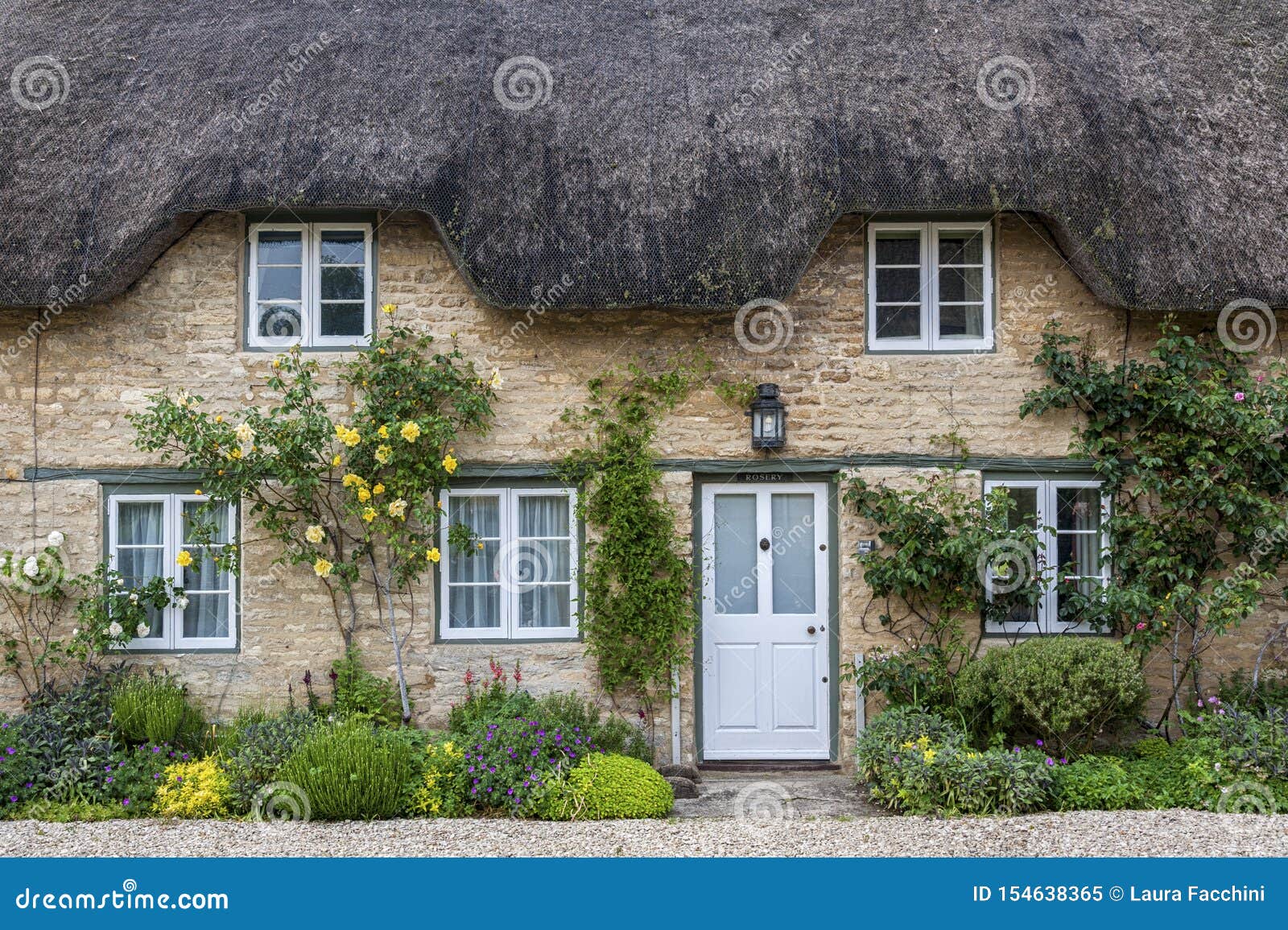 Narrow Lane With Romantic Thatched Houses And Stone Cottages In