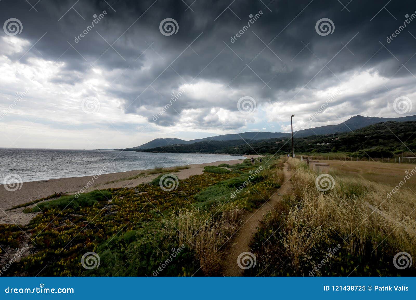 a narrow path on the beach in the dark weather.