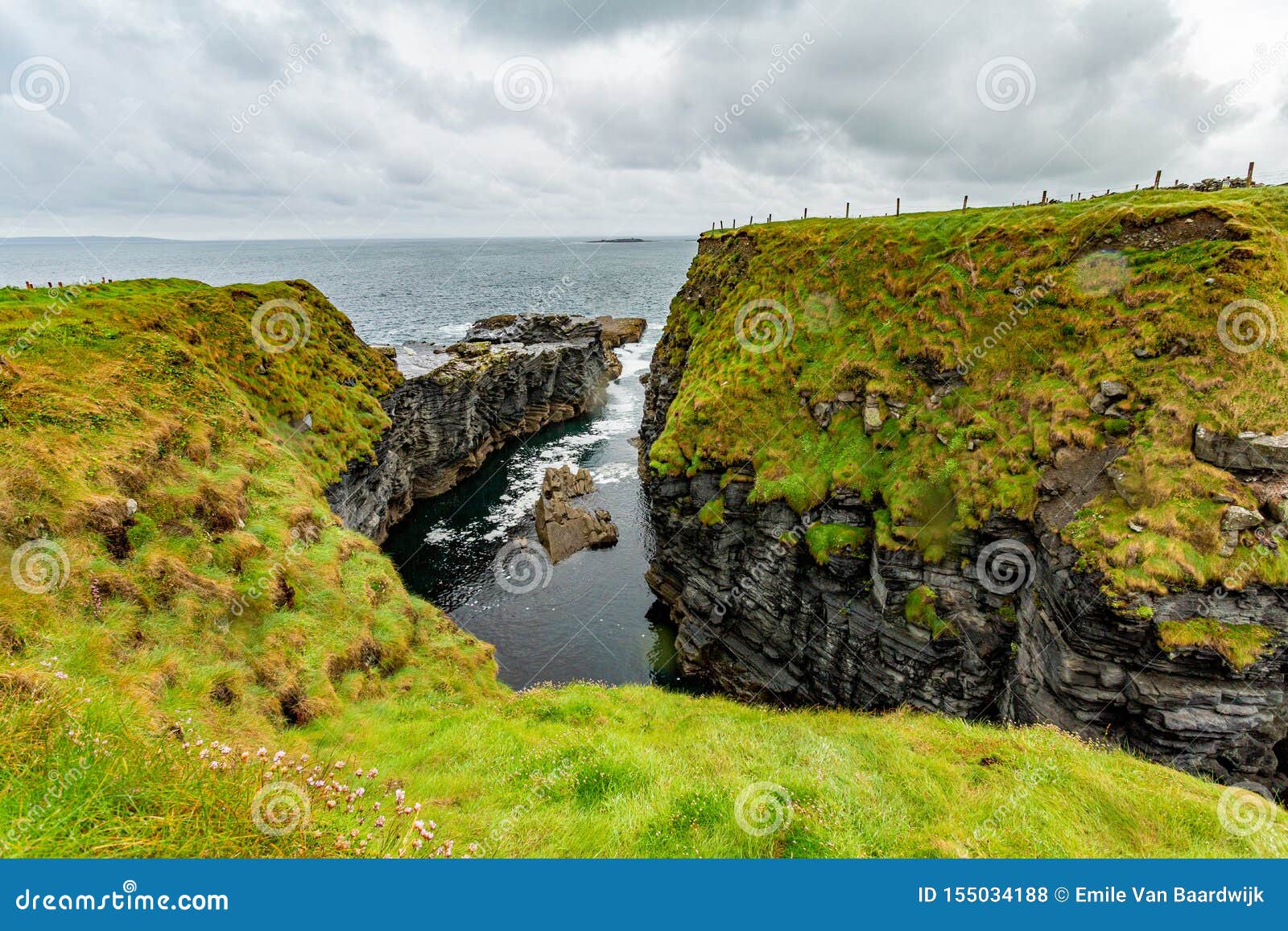 narrow sea inlet between the rocks of a cliff