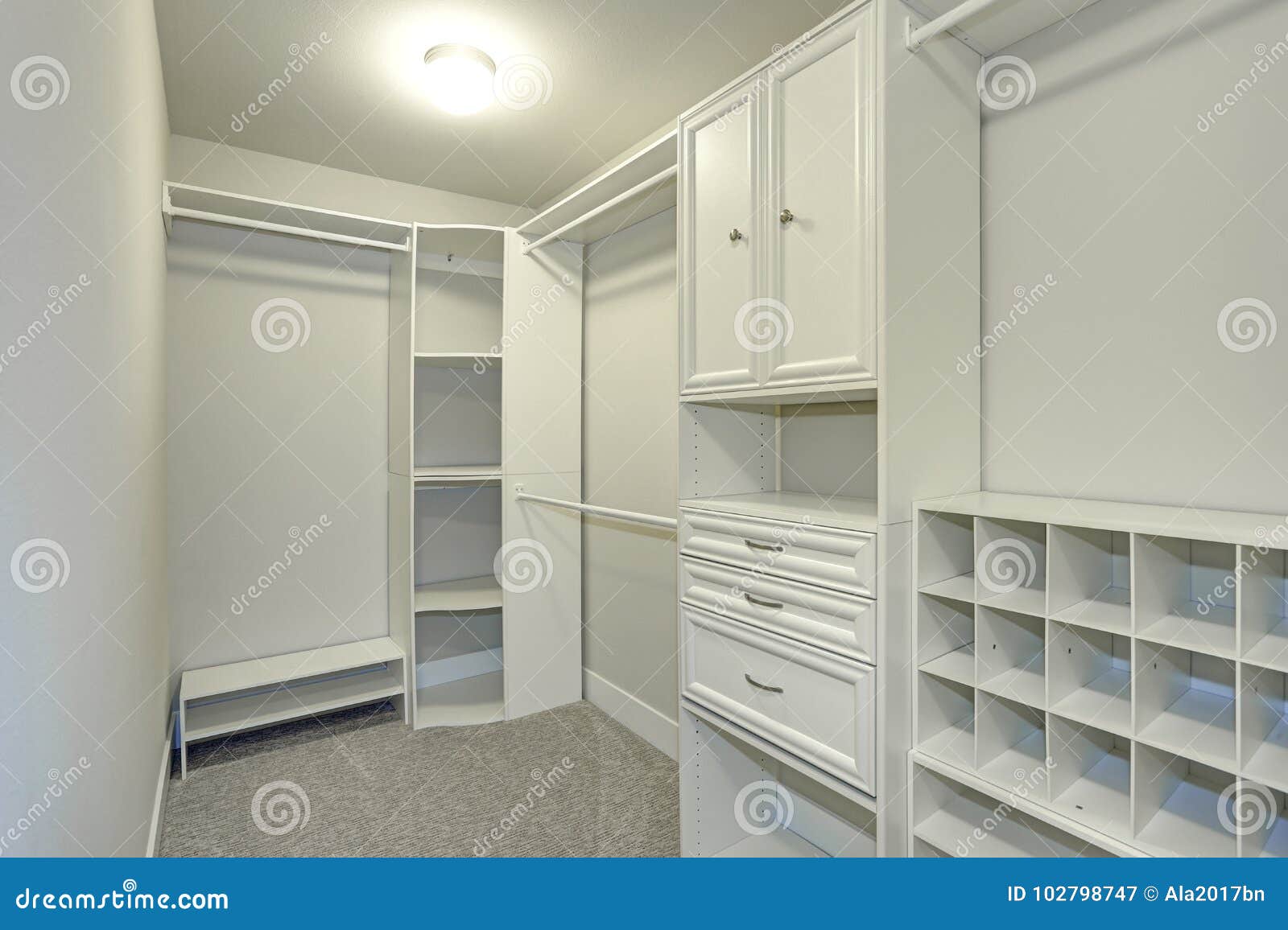 Narrow Walk In Closet Lined With Built In Drawers Stock Image